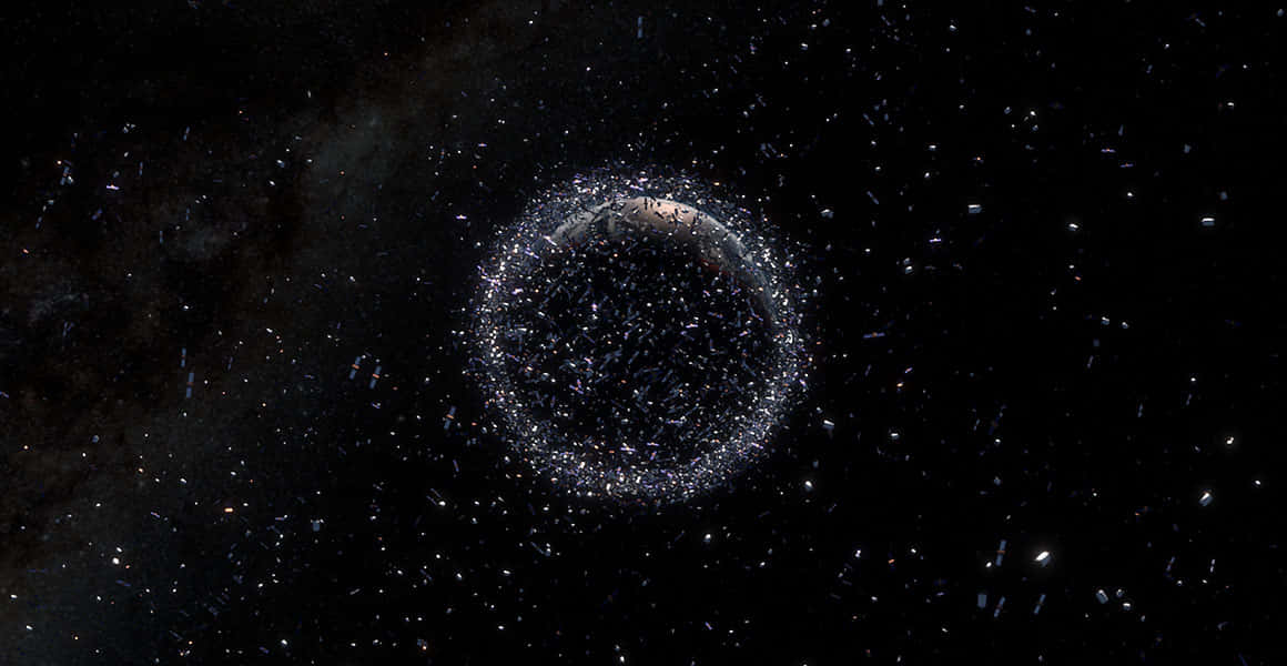 Space Debris 桌布 壁紙 — 一個由閃爍粒子組成的宇宙環，在繁星點點的虛空中繞著一顆黑暗行星運行。