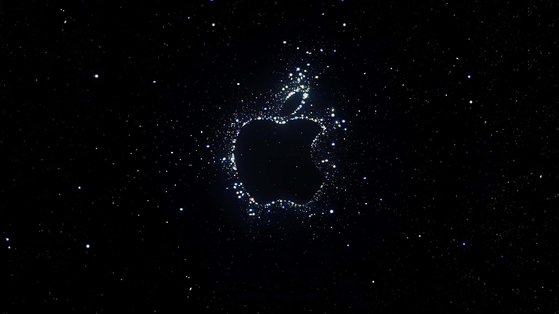 太空 桌布 壁紙 — 一個由閃爍粒子組成的發光Apple標誌，漂浮在星空的宇宙黑色背景上。