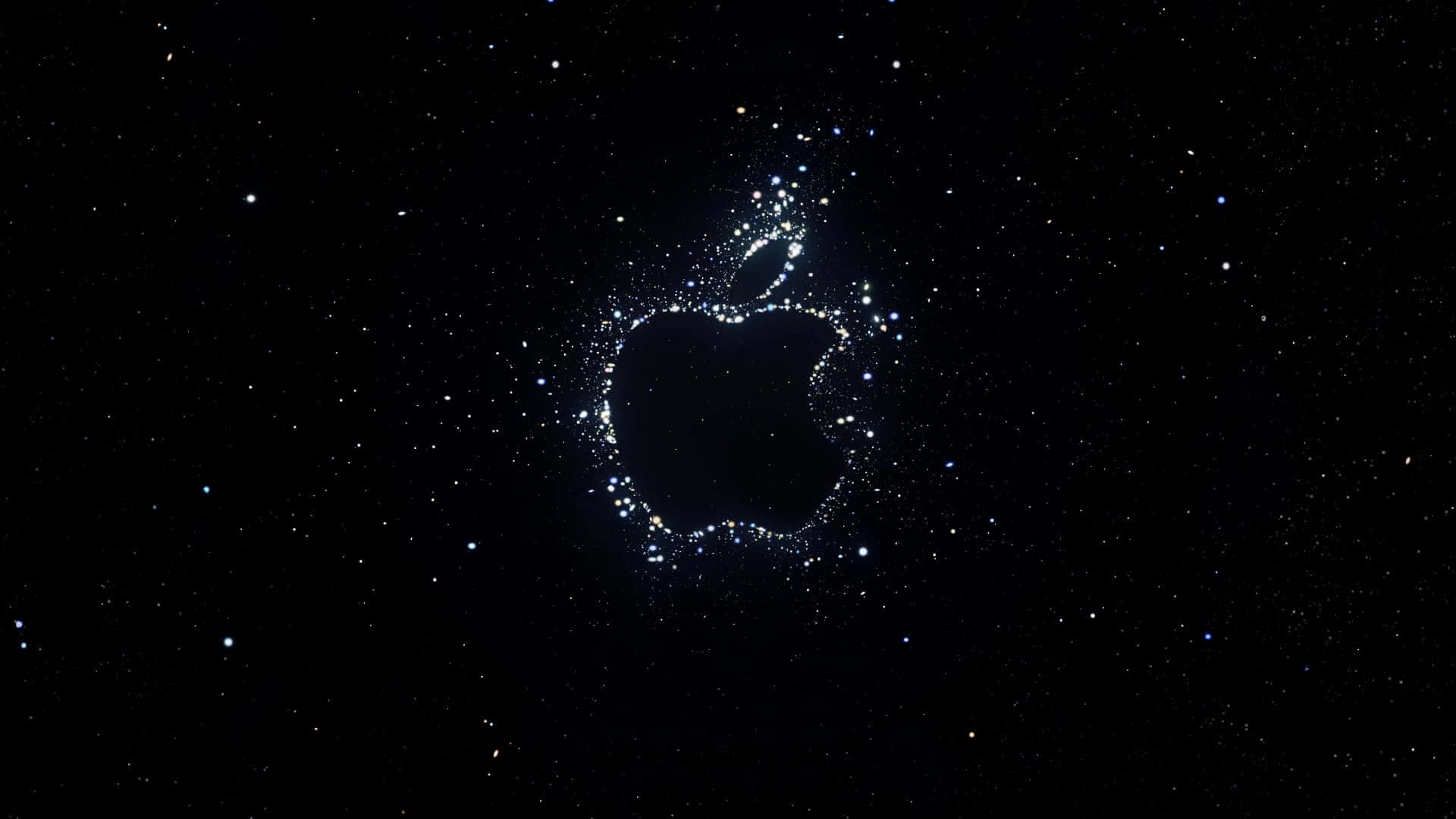 Apple 4K 桌布 壁紙 — 一個由閃爍粒子組成的發光Apple標誌，漂浮在星光燦爛的宇宙黑色背景上。