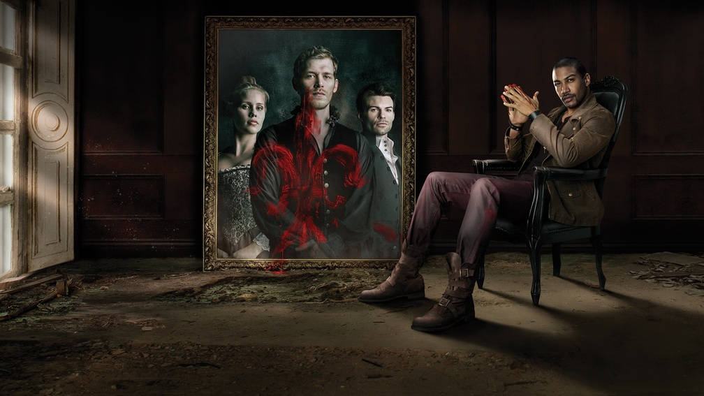elijah mikaelson 桌布 壁紙 — 一個男人坐在昏暗房間的椅子上，旁邊是一幅帶有紅色潑濺效果的肖像畫。