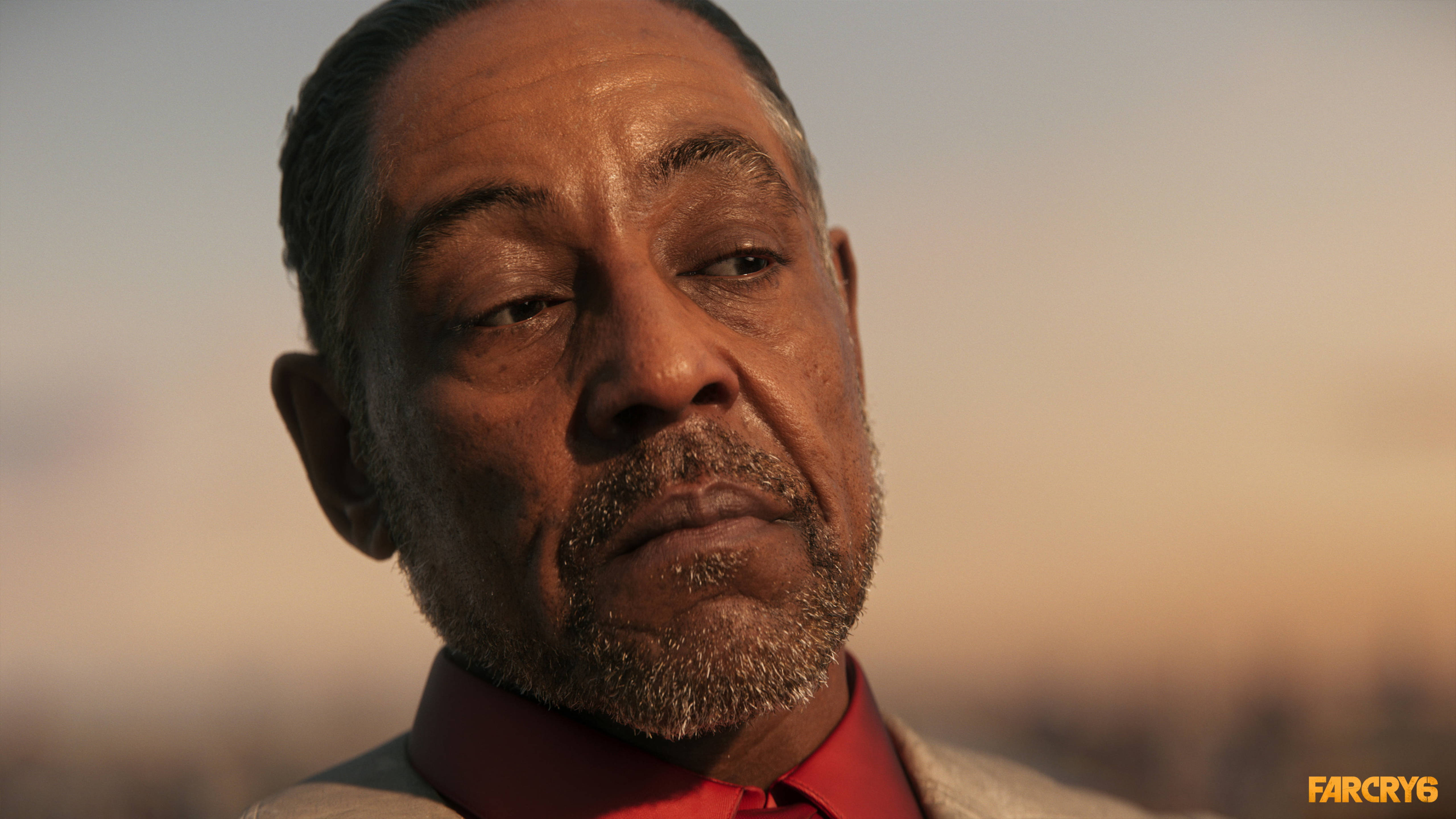Far Cry 6 桌布 壁紙 — 一個男人的特寫肖像，帶著沉思的表情，背景是溫暖的日落天空。