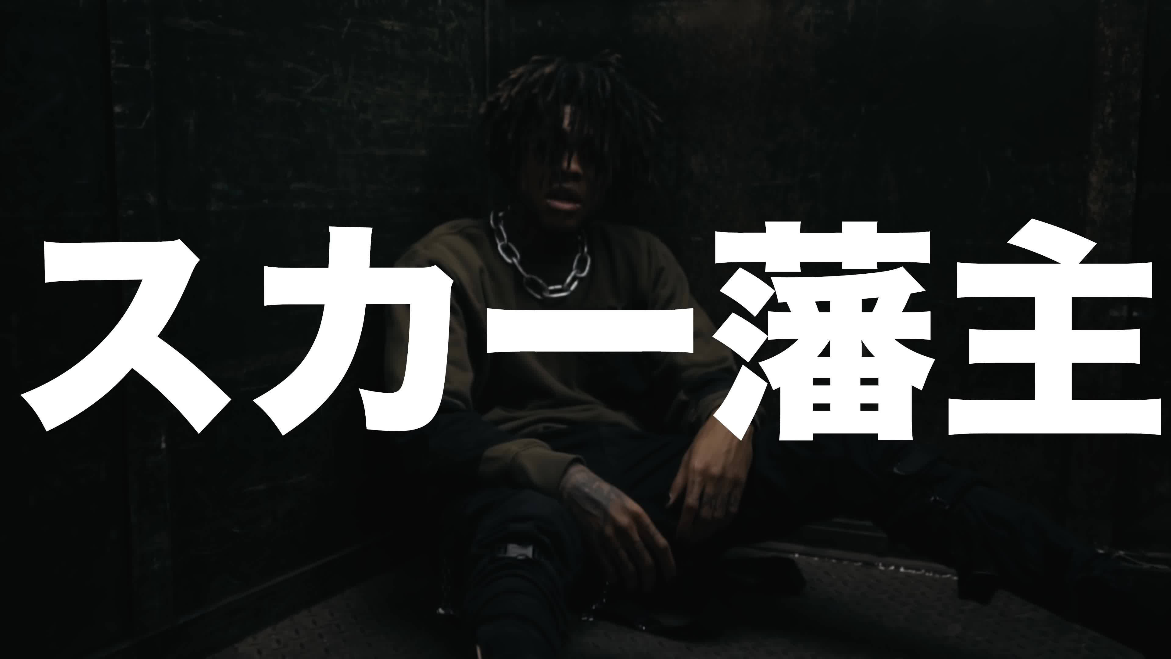scarlxrd 桌布 壁紙 — 一個留著辮子的人坐在昏暗骯髒的空間中，上面覆蓋著粗體白色日文字。