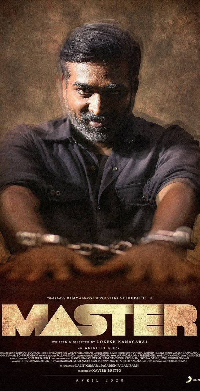 vijay HD 桌布 壁紙 — 一個留鬍子、戴手銬的男人，在帶有紋理的棕色背景上，下方有電影字幕，強烈地凝視著。