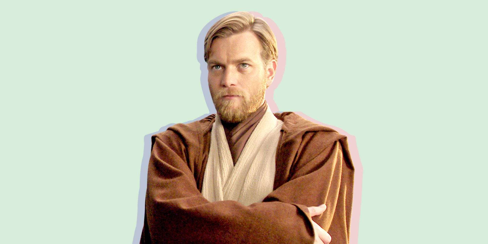Kenobi 桌布 壁紙 — 一個留鬍子、穿著棕色長袍的男人，雙臂交叉，站在淡綠色背景前。