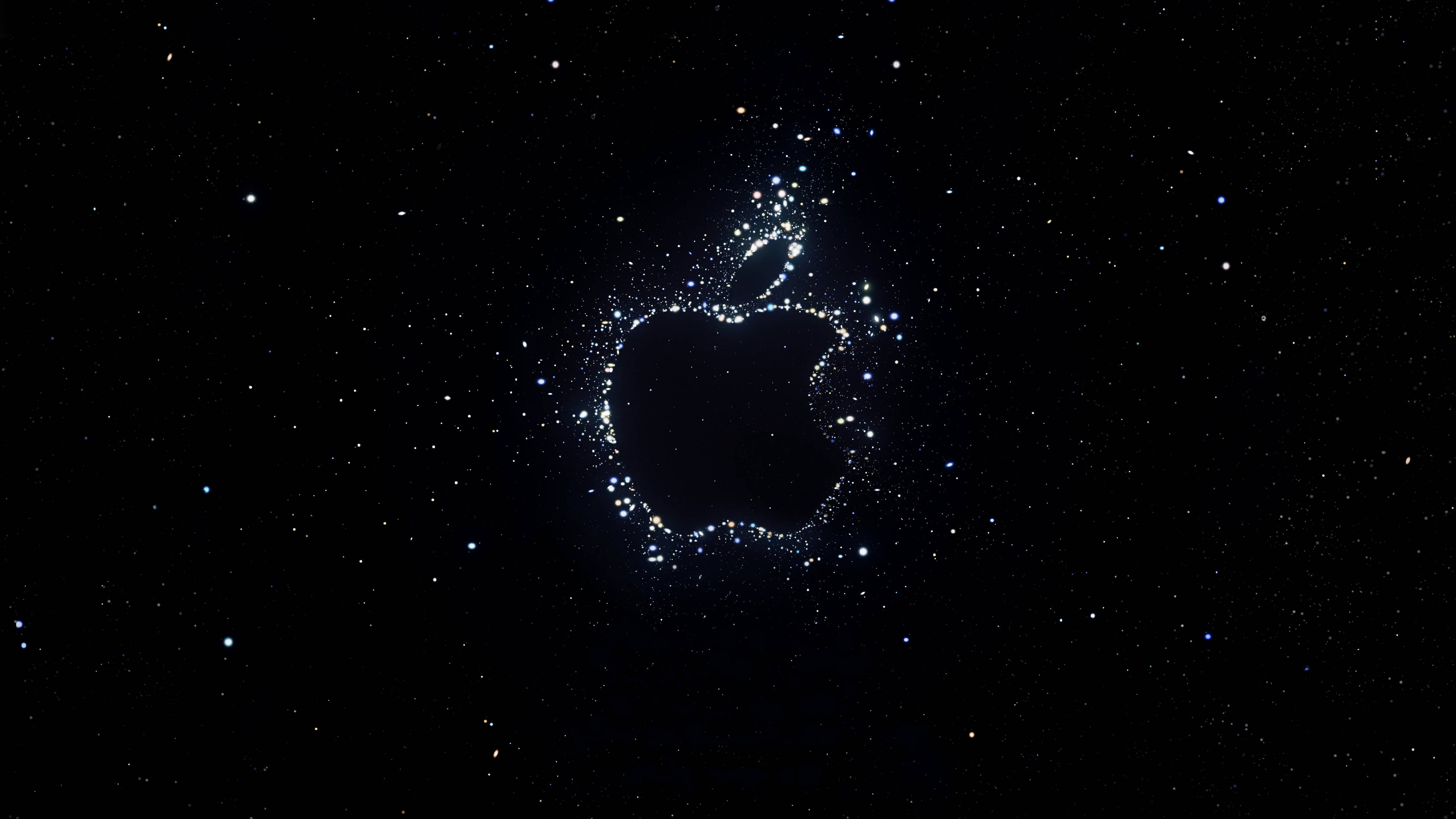 Solid Black 桌布 壁紙 — 一個發光的Apple標誌，由閃爍的星星在深邃的黑色宇宙背景上形成。