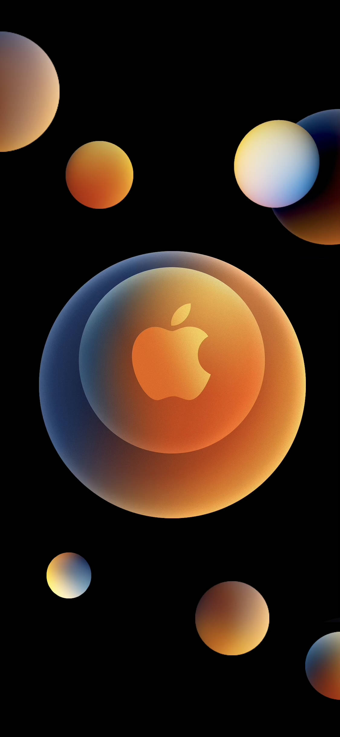 蘋果 桌布 壁紙 — 一個發光的Apple標誌位於漸變球體中央，周圍漂浮著色彩繽紛的球體，背景為黑色。