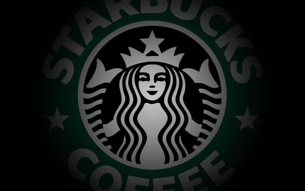 星巴克 桌布 壁紙 — 一個發光的Starbucks標誌，中央有一個女妖圖案，位於深綠色圓圈內，背景為黑色。