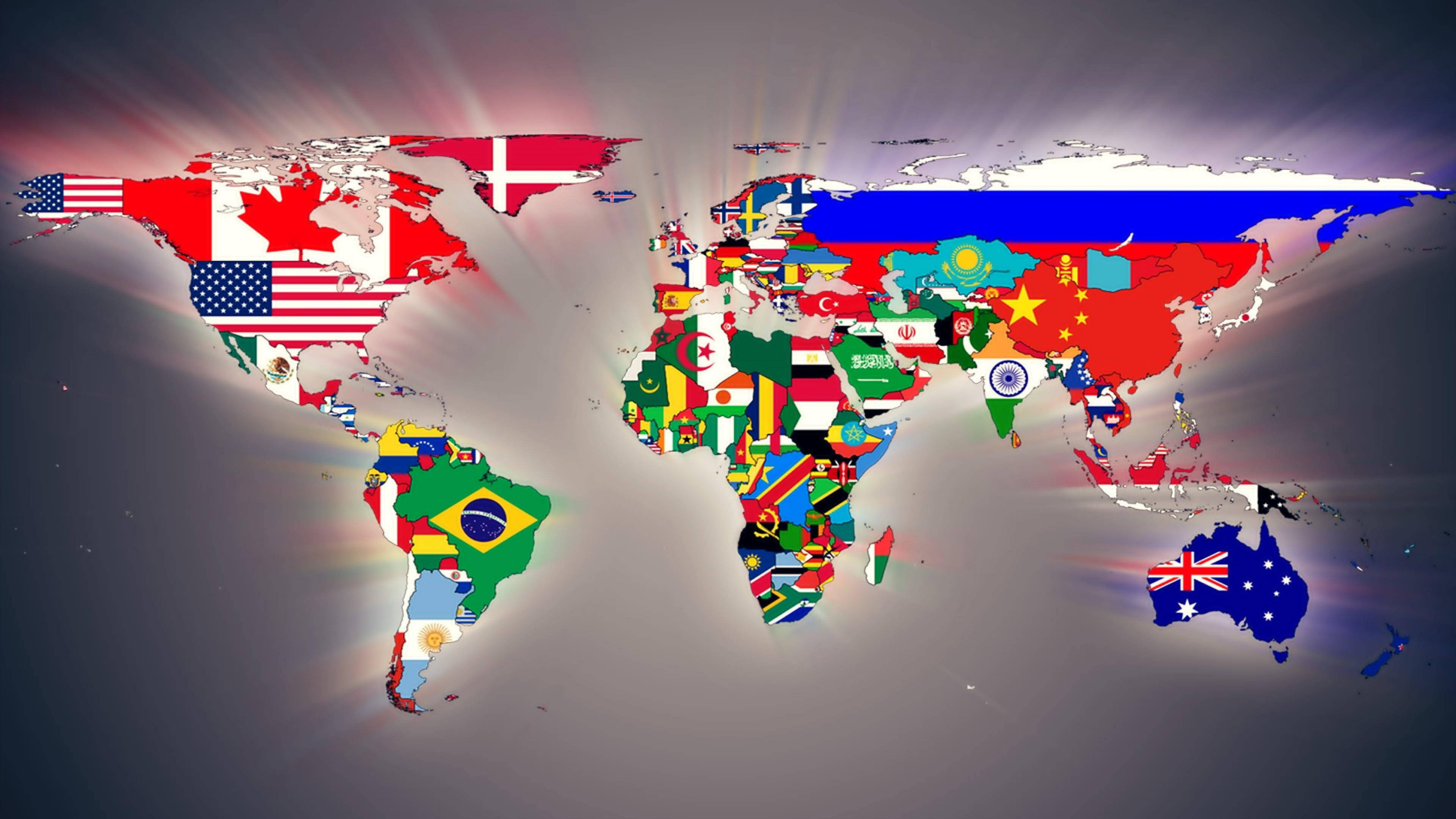 Flag 桌布 壁紙 — 一個發光的世界地圖，每個國家都鮮明地覆蓋著其國旗，並從中心迸發出耀眼的光束。