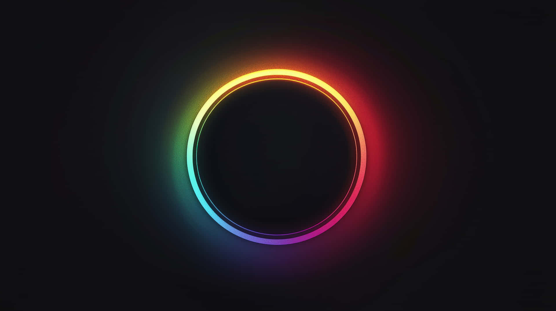 Glowing Neon Circular Ring with a Dark Background and Vibrant Rainbow Colors 壁紙 — 一個發光的彩虹色環在黑暗背景下散發出光芒，形成充滿活力的圓形光譜。