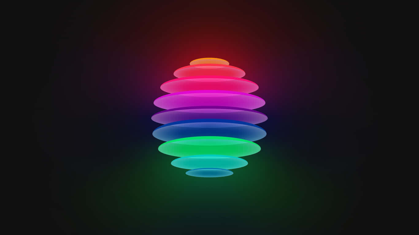 Shapes 桌布 壁紙 — 一個發光的彩虹色疊環雕塑在黑暗背景中散發光芒。