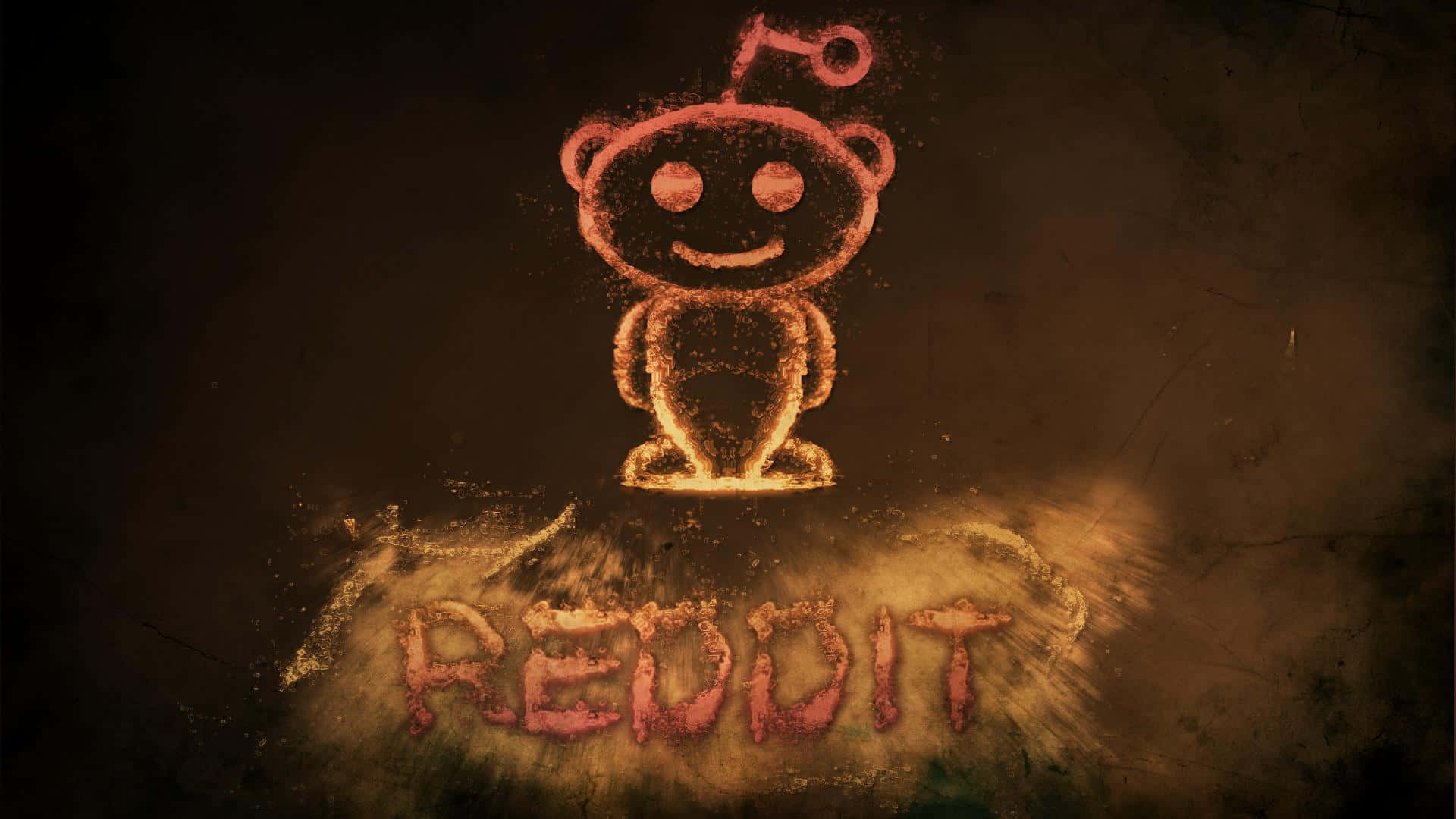 Reddit 桌布 壁紙 — 一個發光的橙色 Reddit 外星人吉祥物，用灰塵繪製，下方有 reddit 字樣，背景為深色紋理。