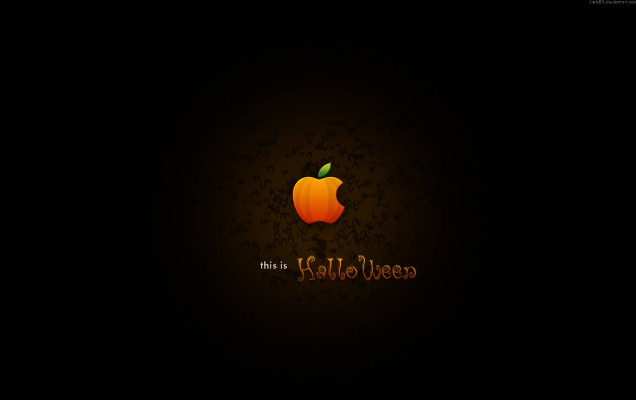 萬聖節 iPhone 桌布 壁紙 — 一個發光的橙色南瓜取代了Apple標誌，背景為深色，帶有模糊的蝙蝠剪影和文字this is Halloween。