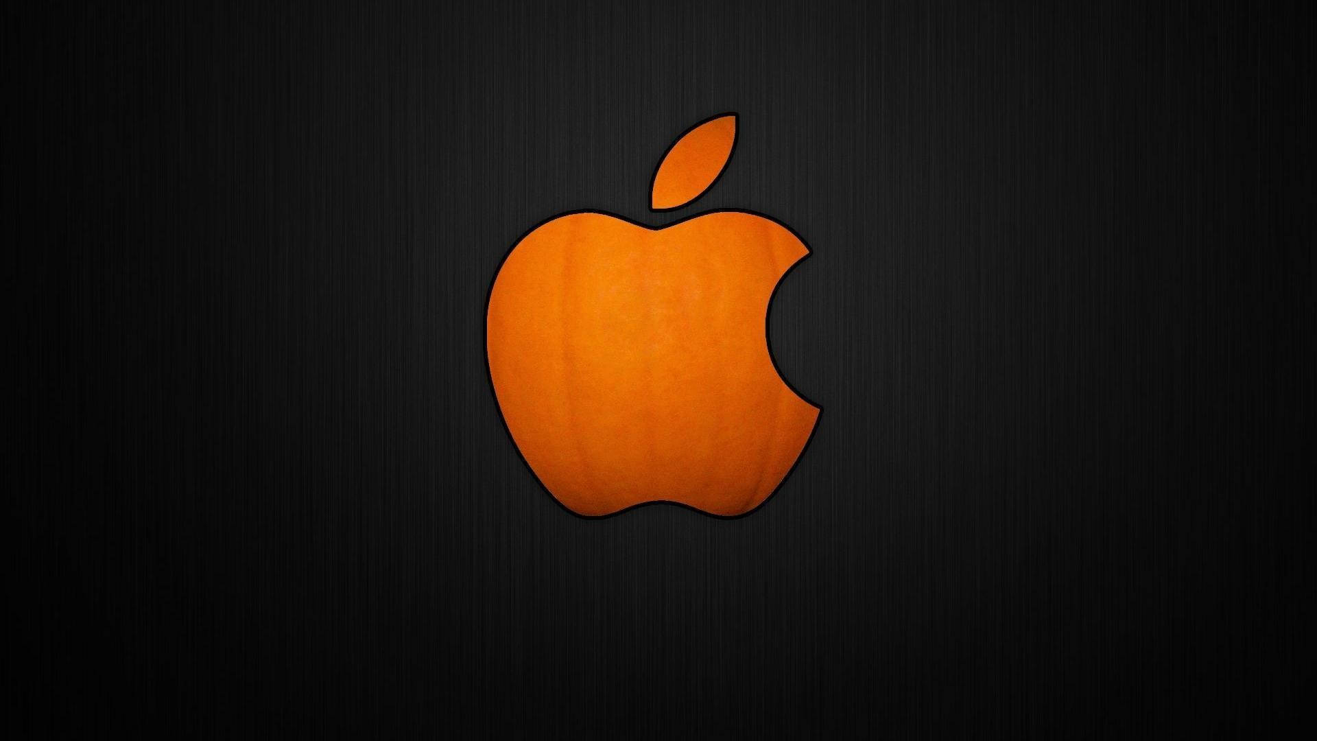 Cool Logos 桌布 壁紙 — 一個發光的橙色蘋果標誌，帶有咬痕，居中在深色紋理背景上。
