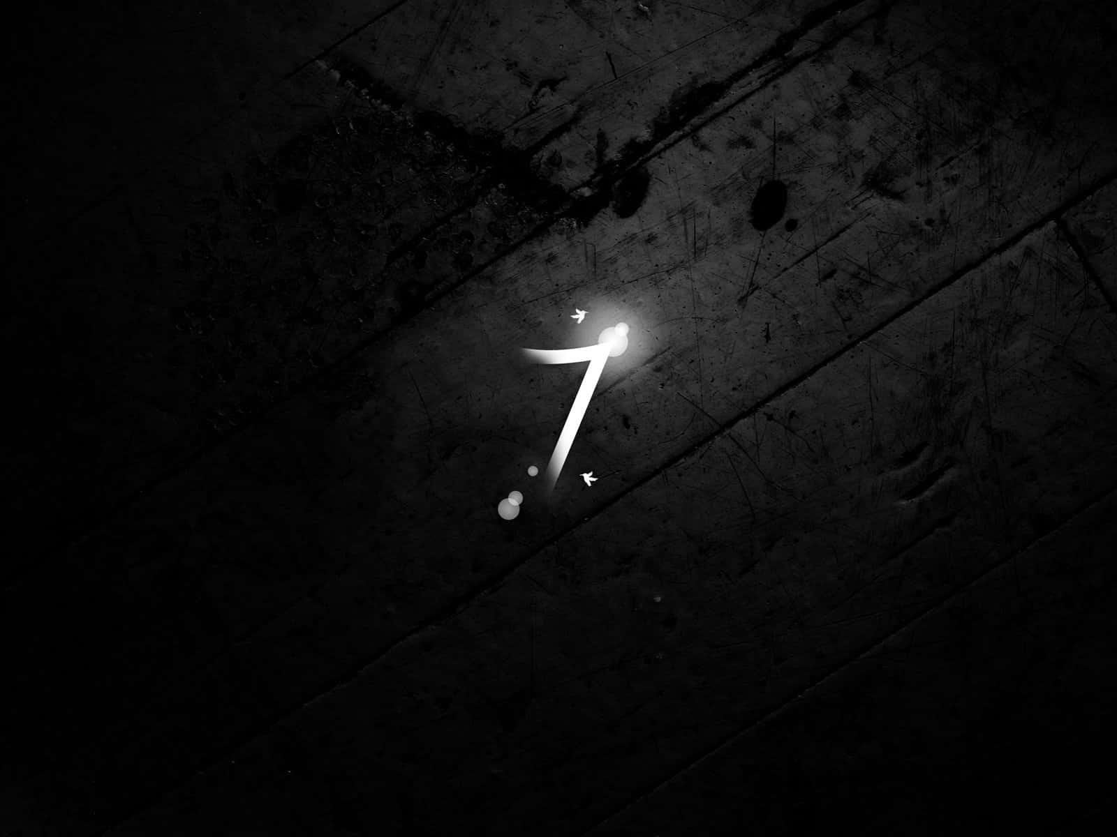 Number 7 桌布 壁紙 — 一個發光的白色數字七躺在黑暗的刮痕混凝土表面上，形成鮮明的單色對比。