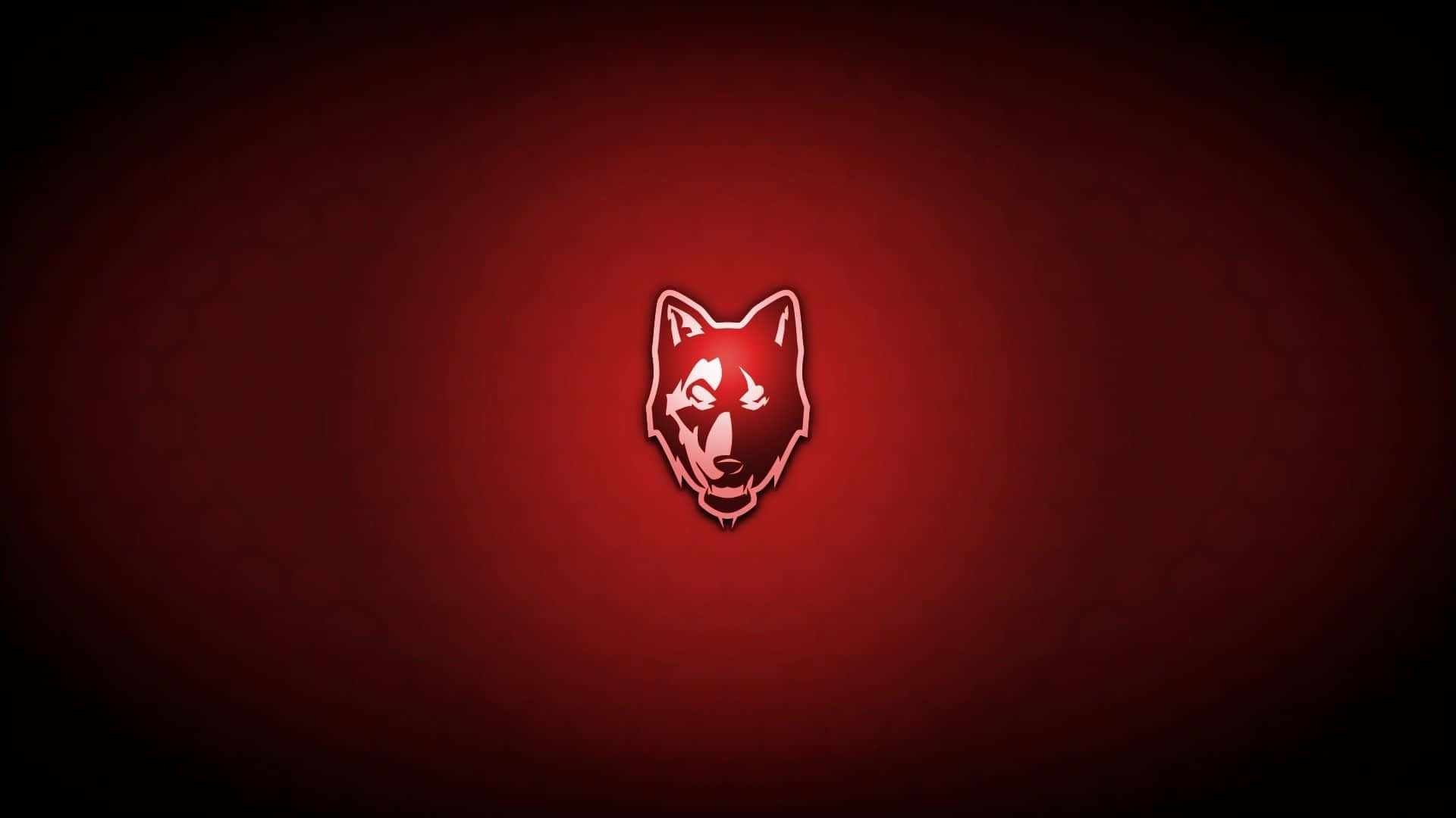 Red Wolf 桌布 壁紙 — 一個發光的白色狼頭標誌，居中於帶有深色邊緣的漸變紅色背景上。