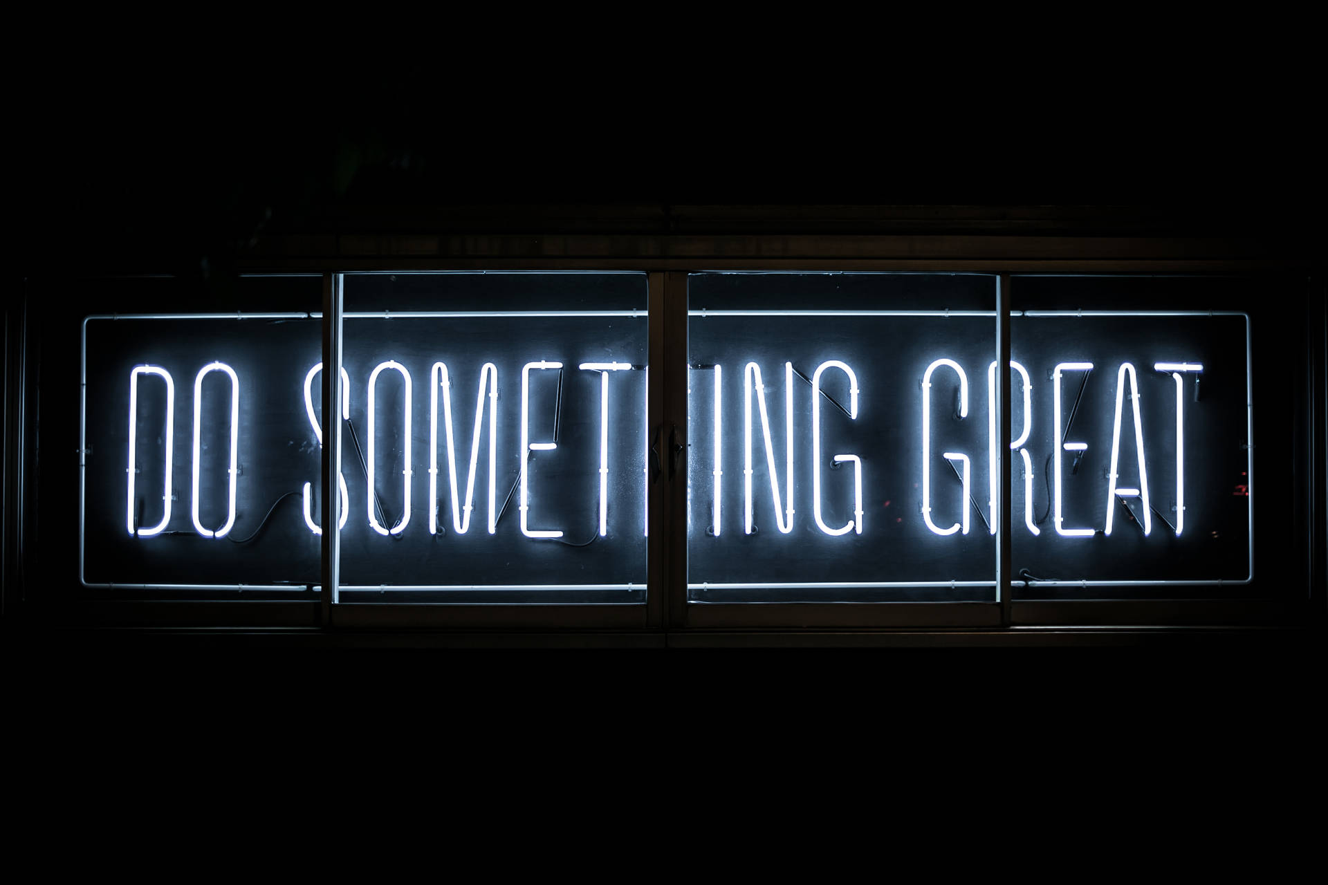 一個明亮的白色霓虹燈牌，上面寫著「Do Something Great」，在黑暗的窗戶中。 — 4K 優雅動漫壁紙 壁紙