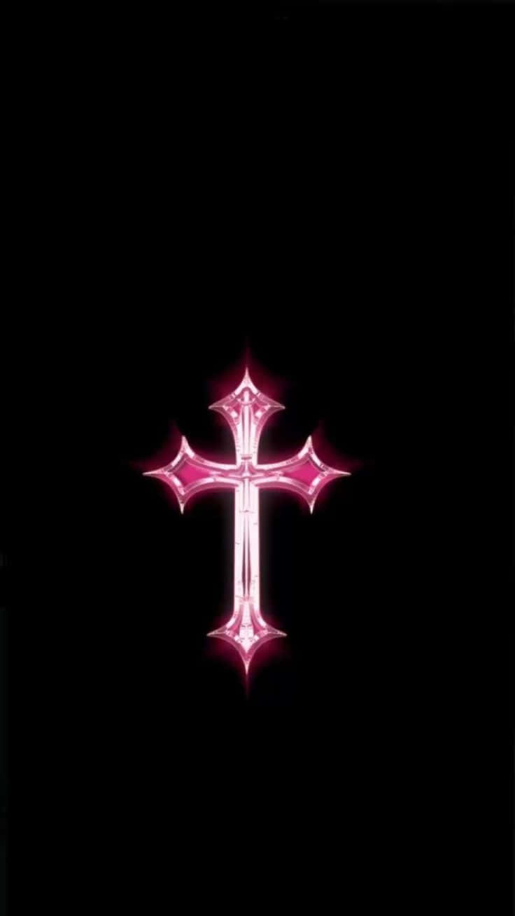 Pink Cross 桌布 壁紙 — 一個發光的粉紅色十字架，帶有尖銳的星形尖端，居中於純黑色背景上。