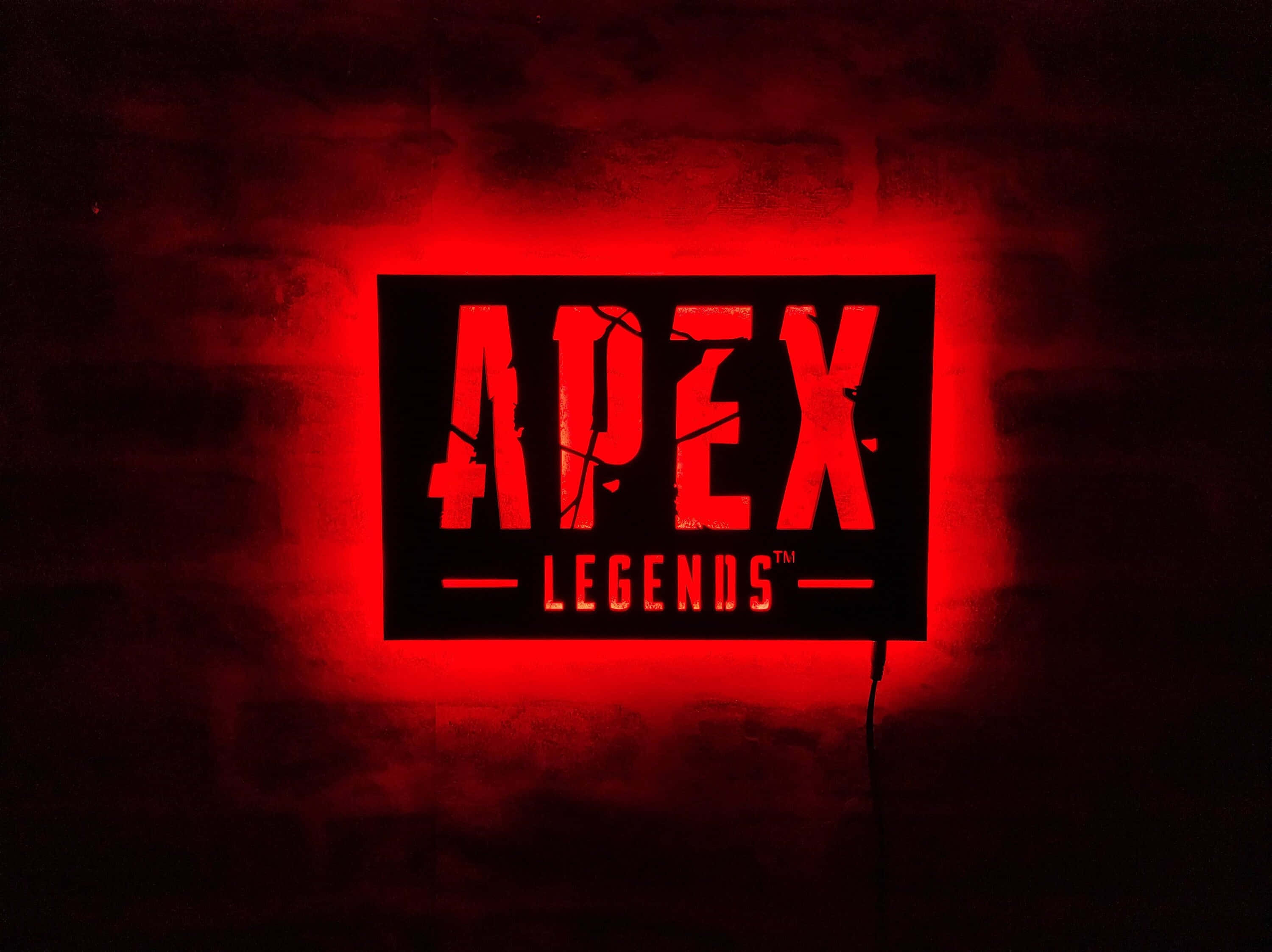 Apex 英雄 桌布 壁紙 — 一個發光的紅色Apex Legends標誌招牌，在昏暗的房間裡向深色磚牆投射出強烈的光芒。