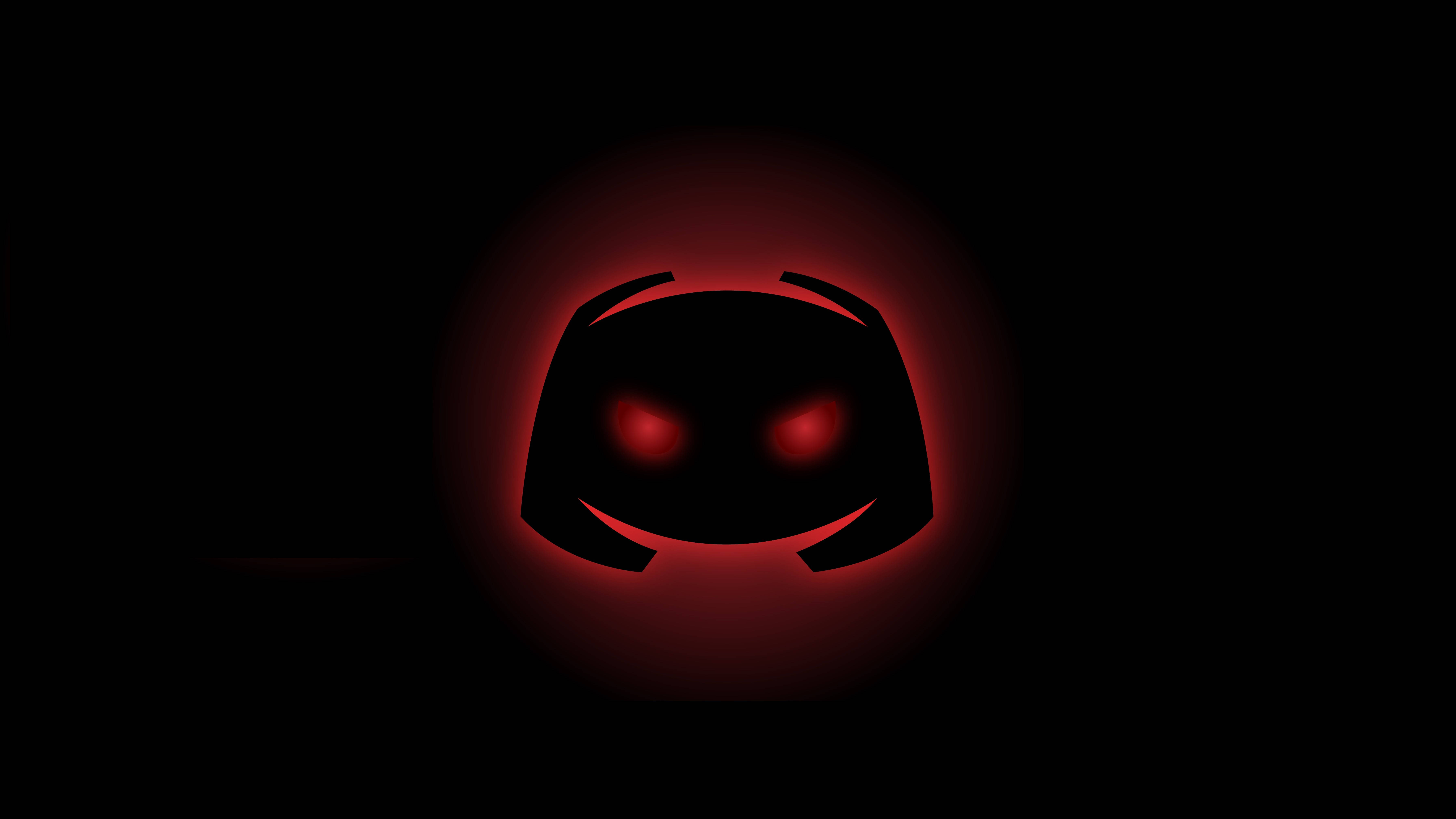 Discord 桌布 壁紙 — 一個發光的紅色Discord標誌，帶有發光的眼睛，在黑色背景上脈動。