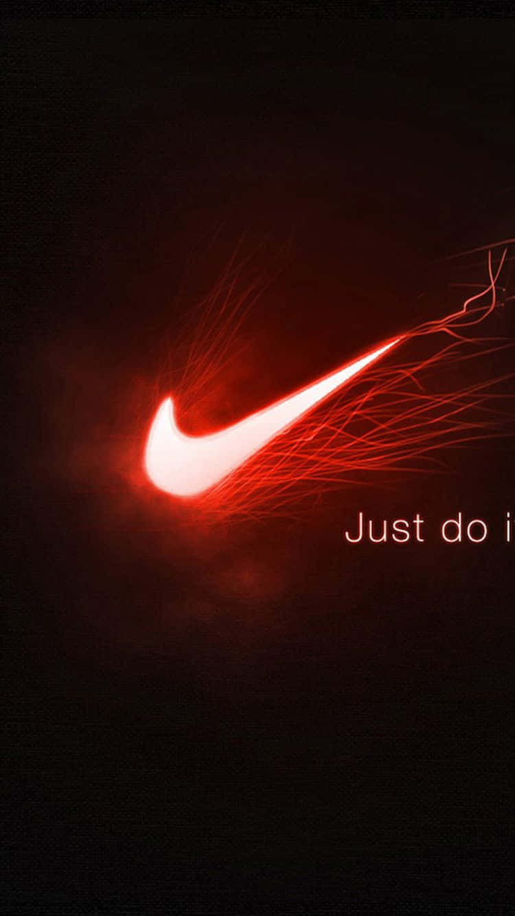 Red Nike 桌布 壁紙 — 一個發光的紅色Nike勾勾在深色背景上爆發出火熱能量，並帶有柔和紅色的文字「Just do it」。