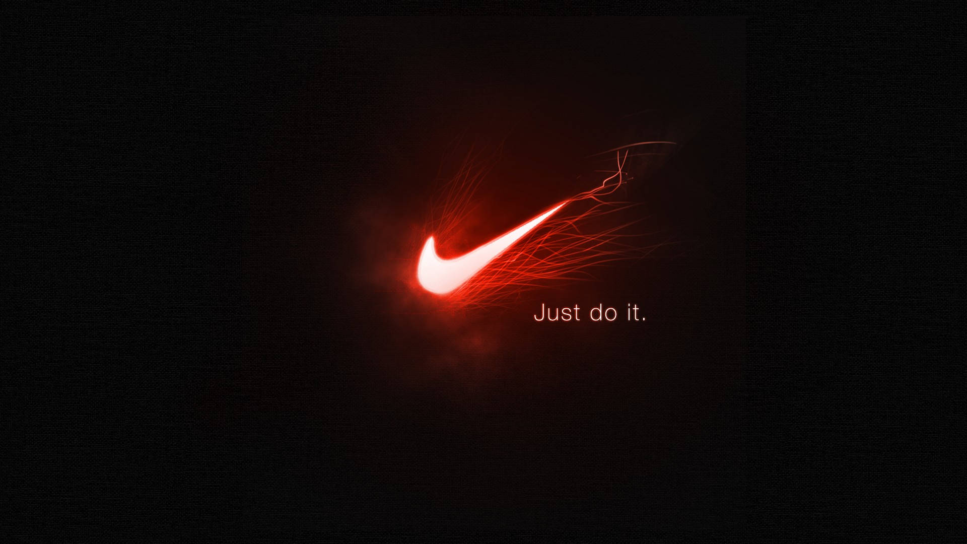Just Do It 桌布 壁紙 — 一個發光的紅色Nike勾勾在黑色背景上爆發出火熱能量，並帶有「Just do it.」文字。