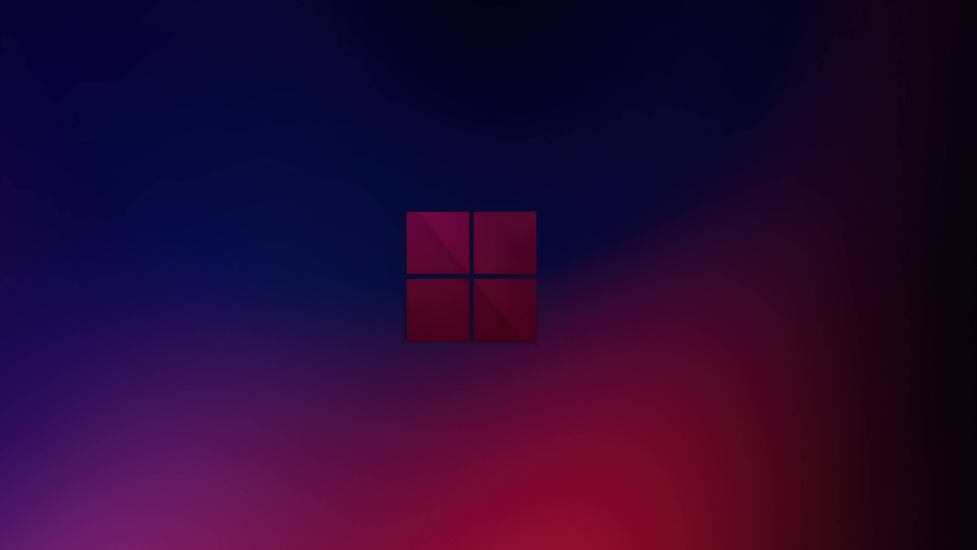 Windows 11 桌布 壁紙 — 一個發光的紅色Windows標誌，居中於從深藍色漸變到充滿活力的洋紅色的背景上。