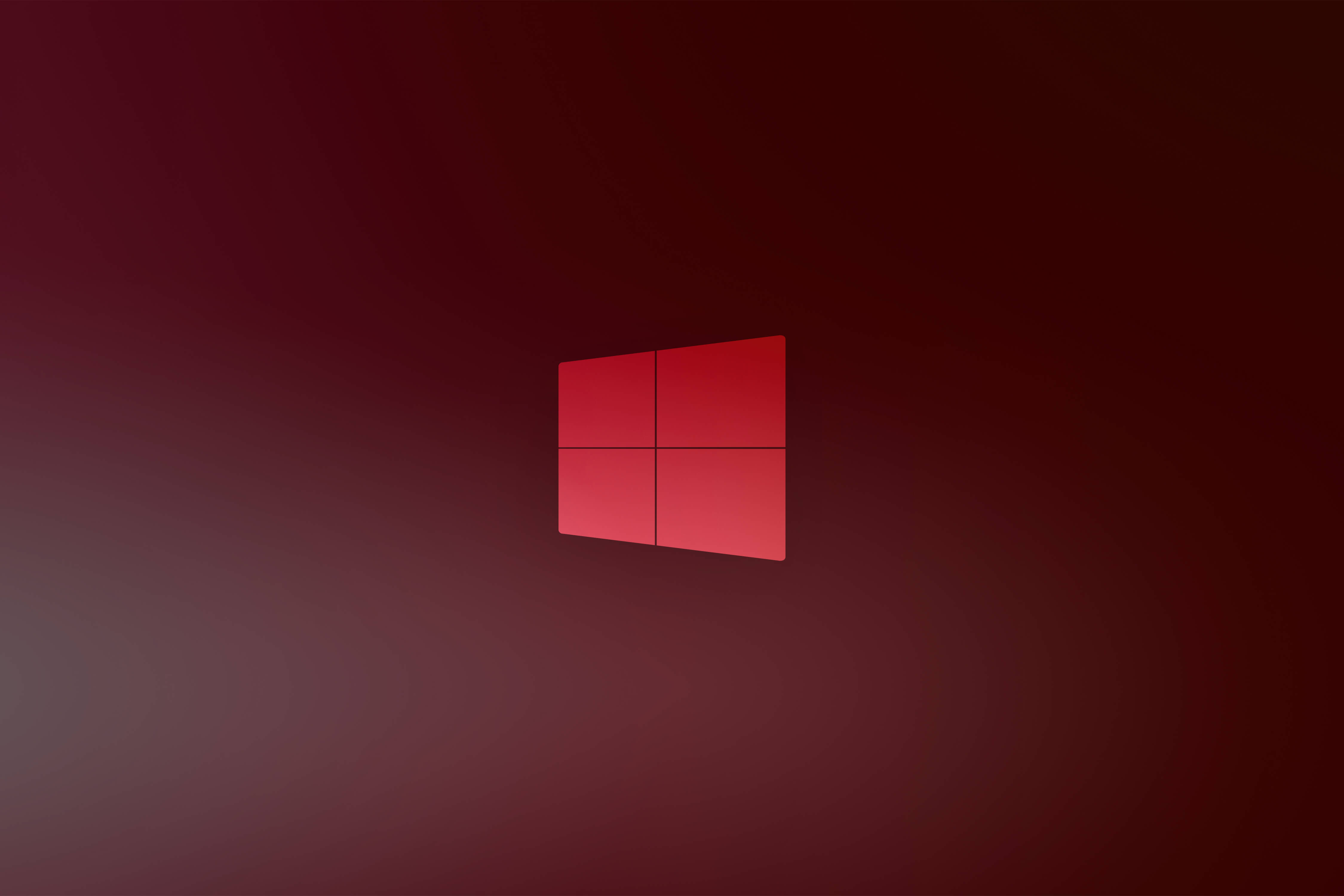Windows 10 高畫質 桌布 壁紙 — 一個發光的紅色Windows標誌，居中於漸變栗色背景上，帶有柔和的光線。