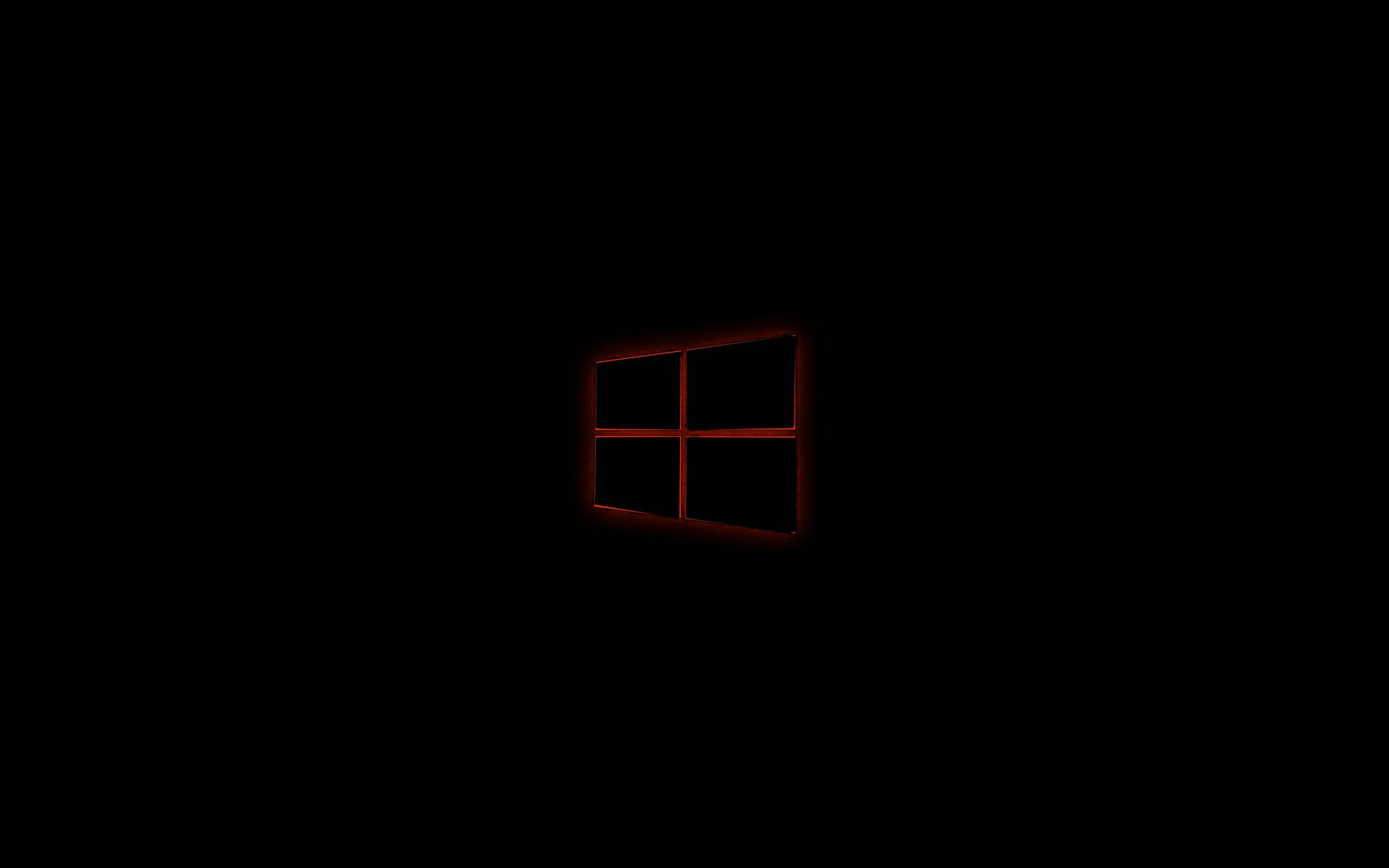黑色 Windows 10 桌布 壁紙 — 一個發光的紅色Windows標誌置於絕對黑暗中，投射出微妙的環境光。