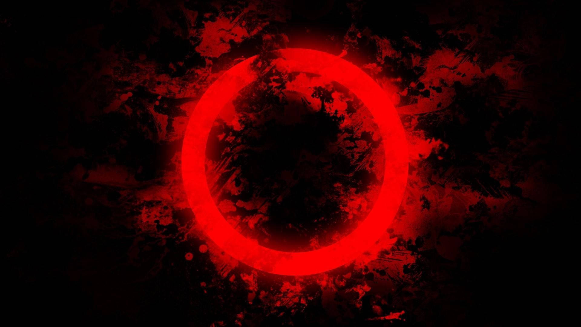 Red Circle 桌布 壁紙 — 一個發光的紅色圓環在黑暗的飛濺背景上脈動，帶有火紅色的點綴。