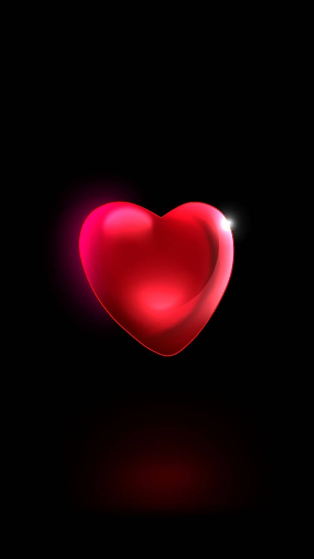 Heart 桌布 壁紙 — 一個發光的紅色心形，帶有明亮的亮點，漂浮在純黑色背景上，下方投射出柔和的紅色陰影。