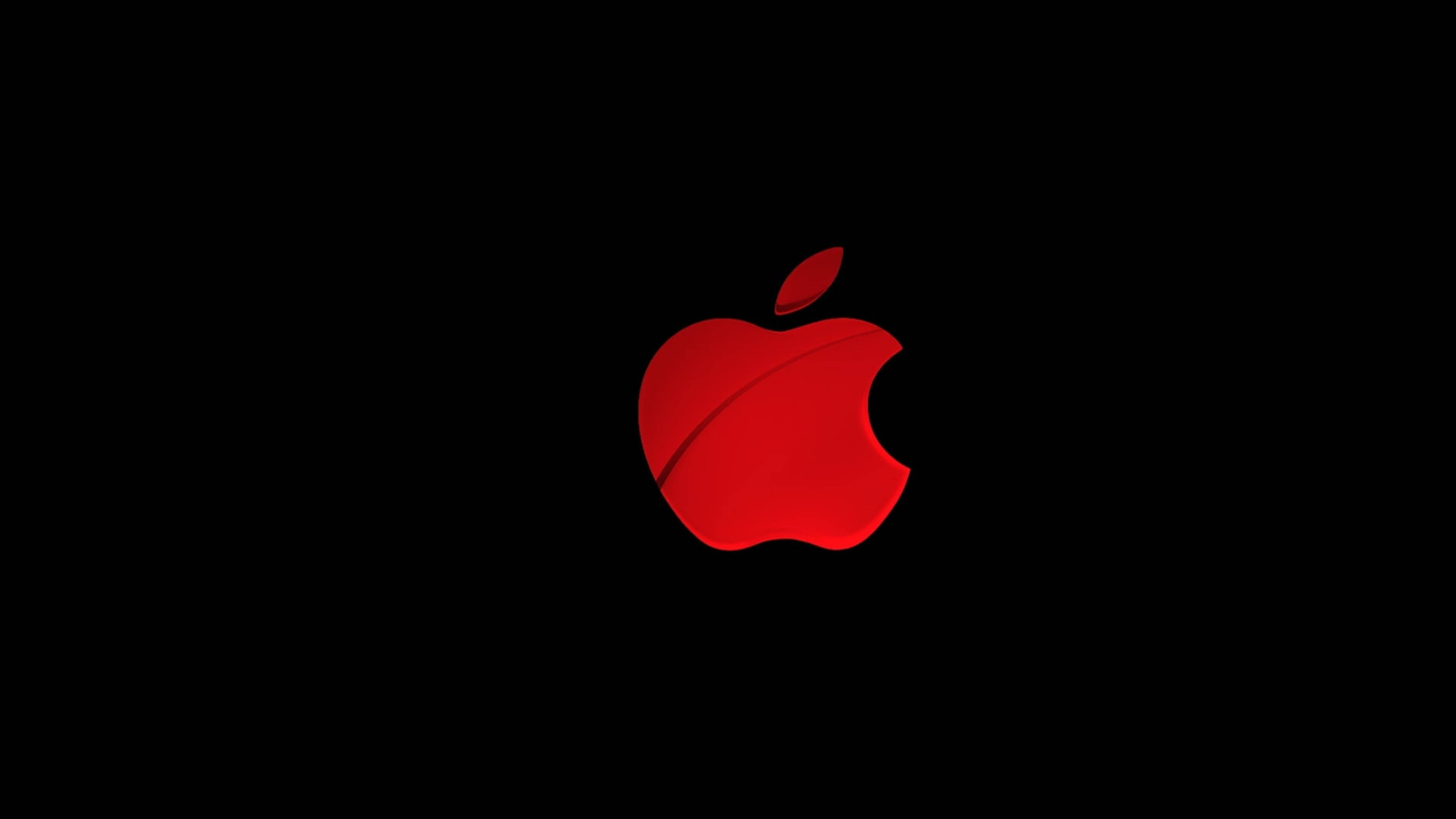 Apple 4K Ultra HD 桌布 壁紙 — 一個發光的紅色蘋果標誌，帶有咬痕，居中在純黑色背景上。