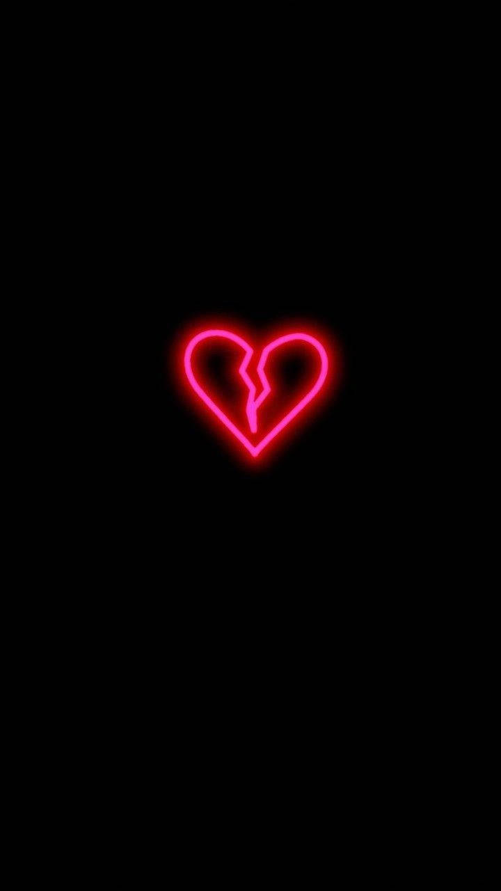 Broken Heart 桌布 壁紙 — 一個發光的紅色霓虹心形，中間有一道裂縫，獨自矗立在漆黑的背景上。