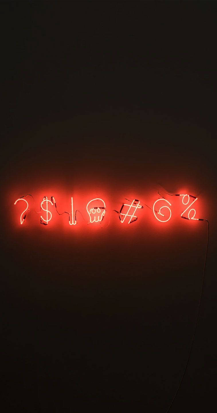 lights 桌布 壁紙 — 一個發光的紅色霓虹燈牌在黑暗的牆上顯示符號，包括問號、美元、骷髏頭和百分比。