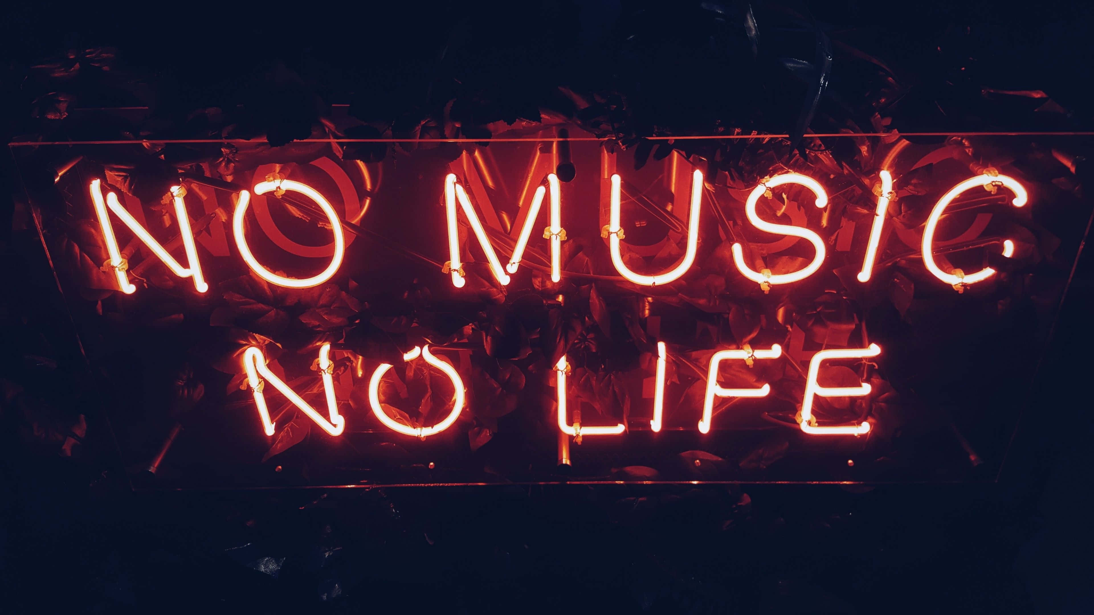 Black Red Neon 桌布 壁紙 — 一個發光的紅色霓虹燈牌寫著「NO MUSIC NO LIFE」，背景是深色的樹葉。