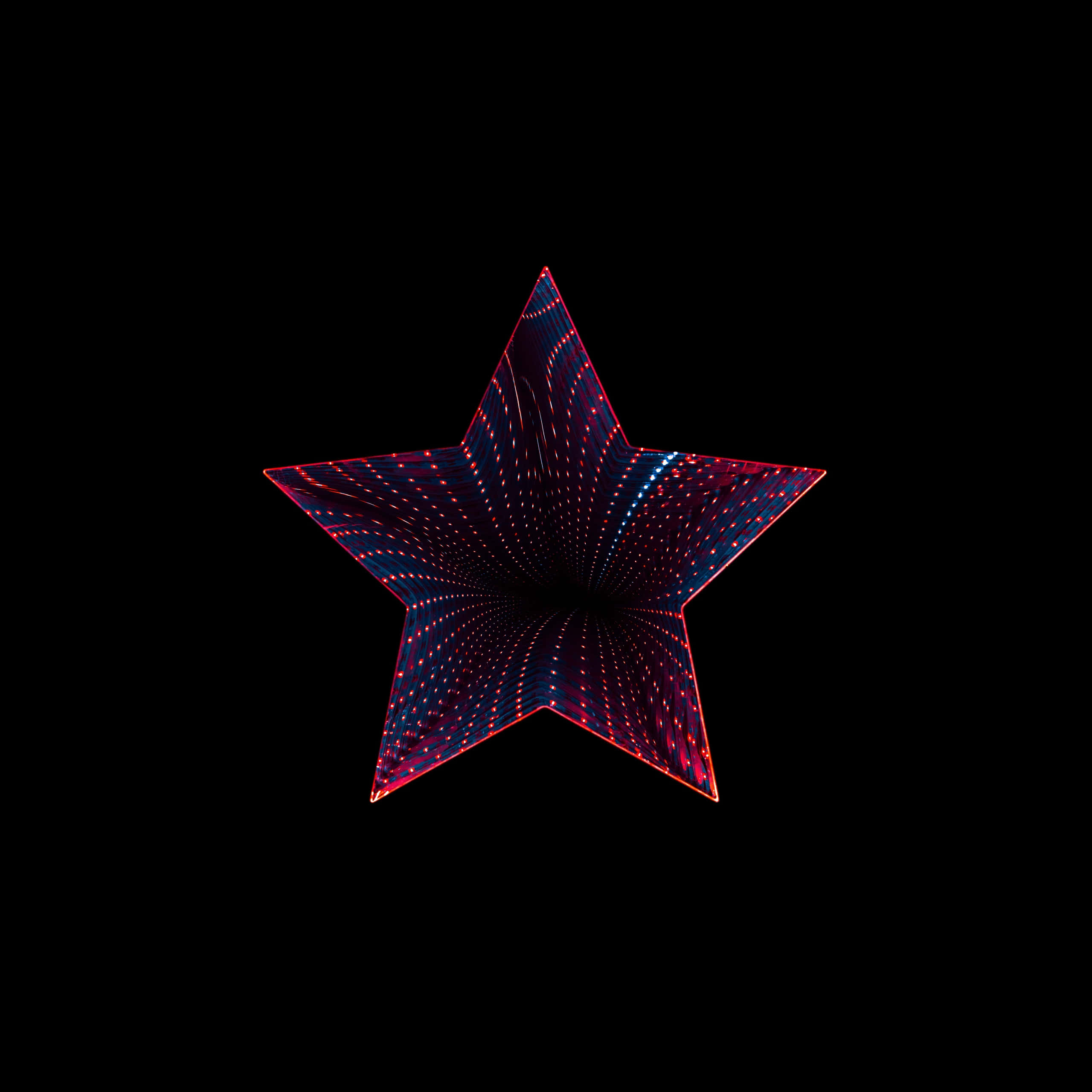 星星動圖 桌布 壁紙 — 一個發光的紅藍星形隧道，帶有虛線燈光，在黑色背景中逐漸消失在黑暗中。