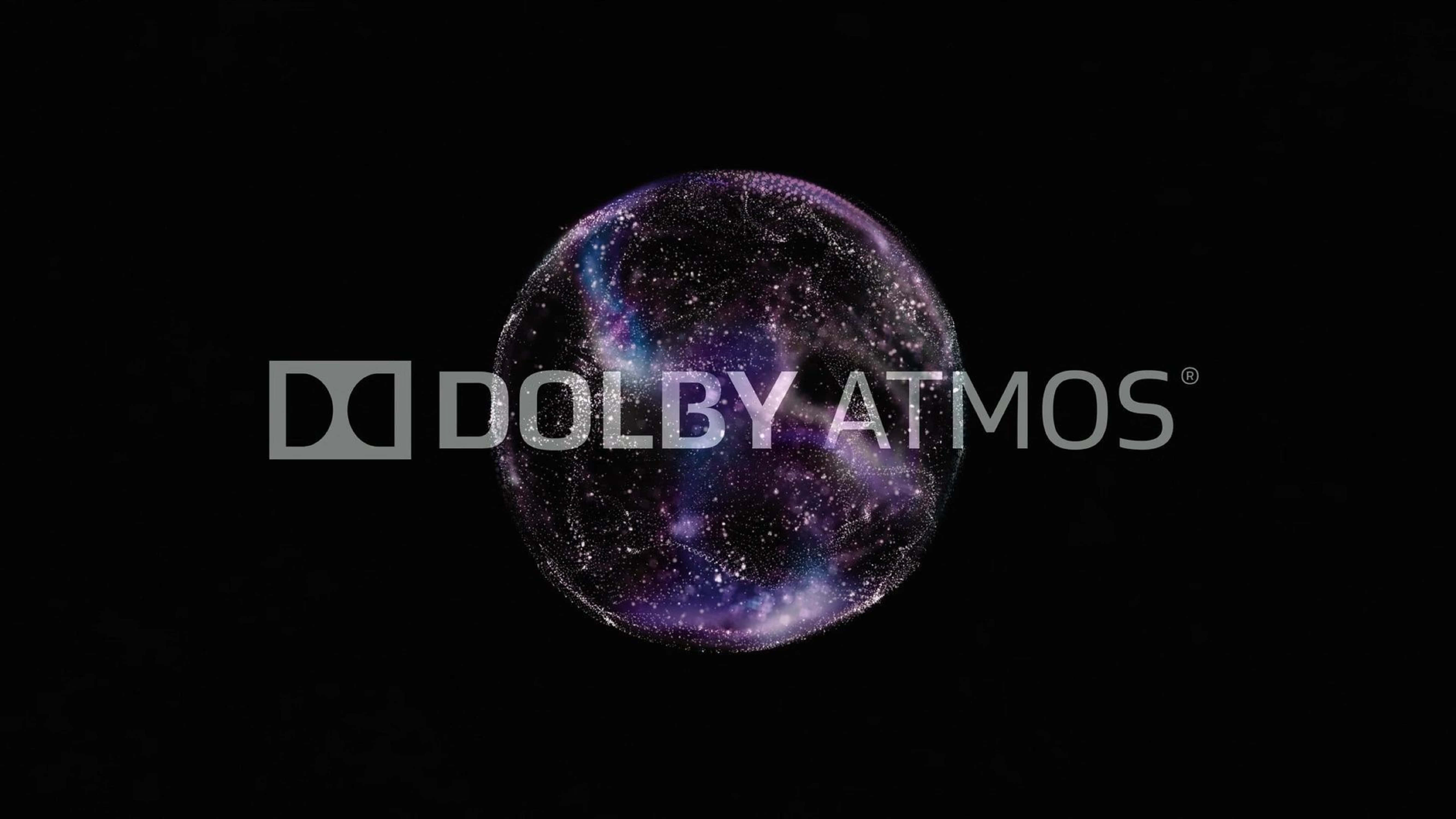 4K Dolby Vision 桌布 壁紙 — 一個發光的紫色和藍色星系球體漂浮在黑色虛空上，帶有 'Dolby Atmos' 文字疊加。