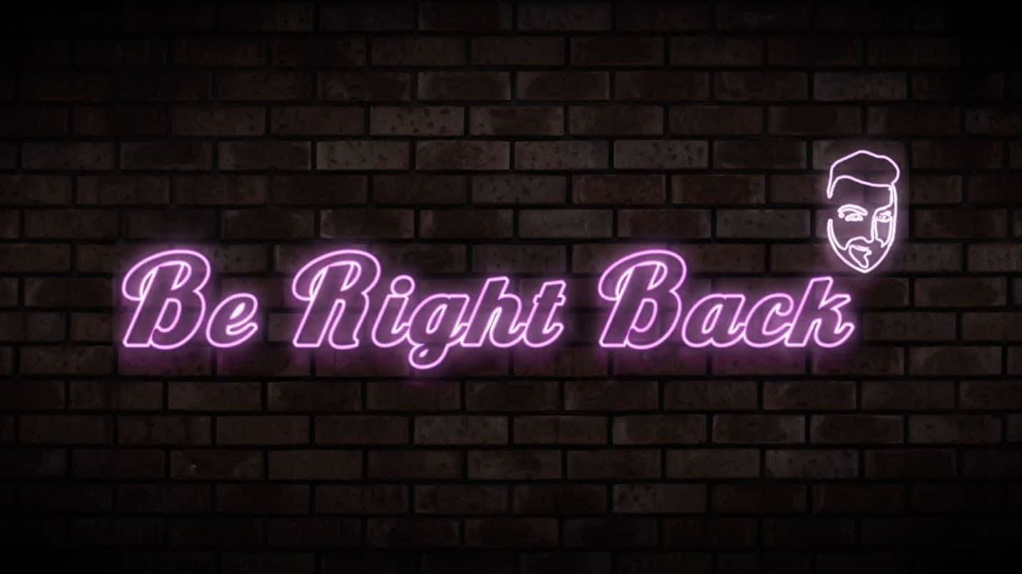 Be Right Back 桌布 壁紙 — 一個發光的紫色霓虹燈牌，上面寫著「Be Right Back」，並帶有一個臉部圖標，安裝在深色磚牆上。