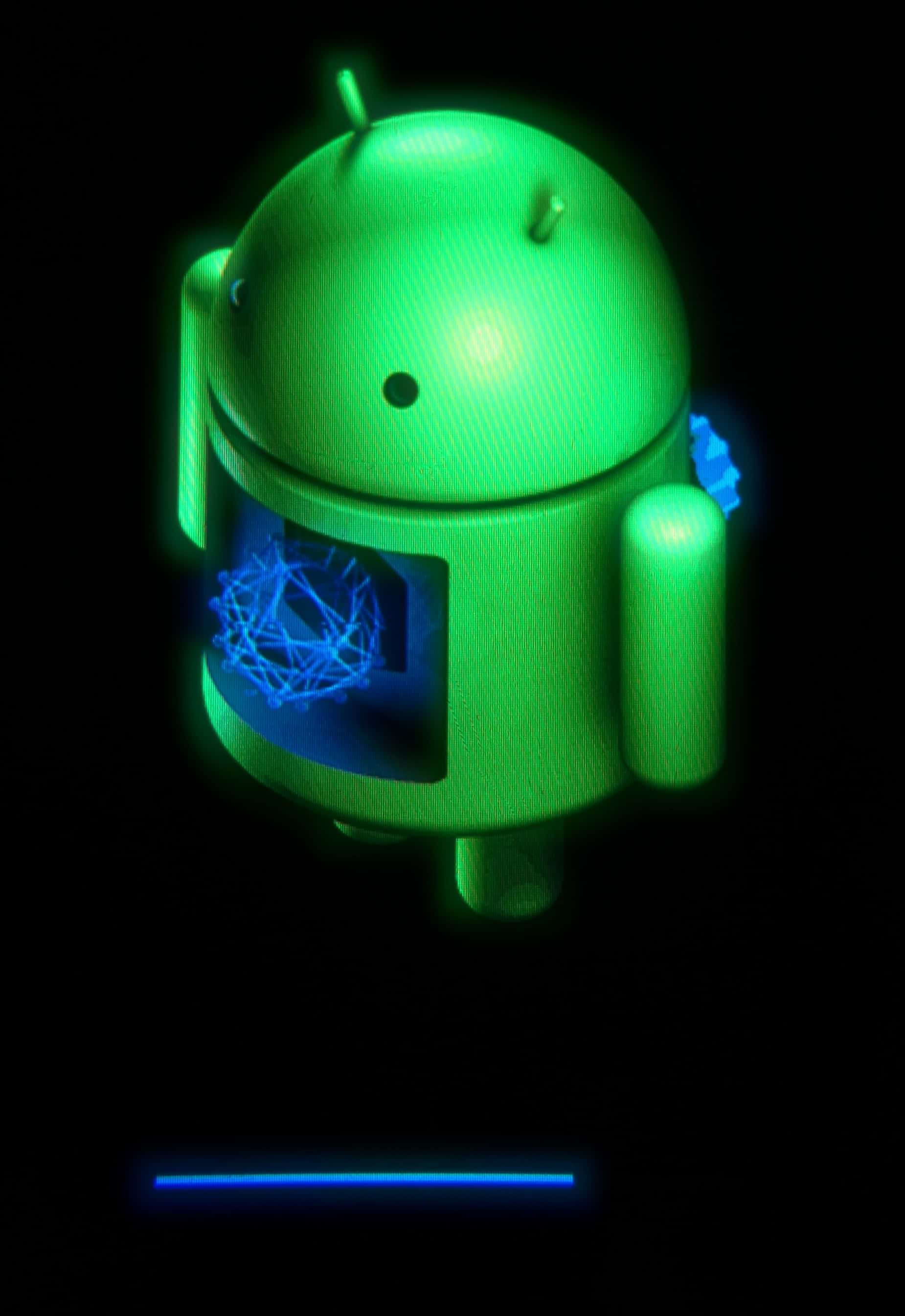 安卓 桌布 壁紙 — 一個發光的綠色Android機器人公仔，胸前有一個藍色幾何球體，背景為黑色。