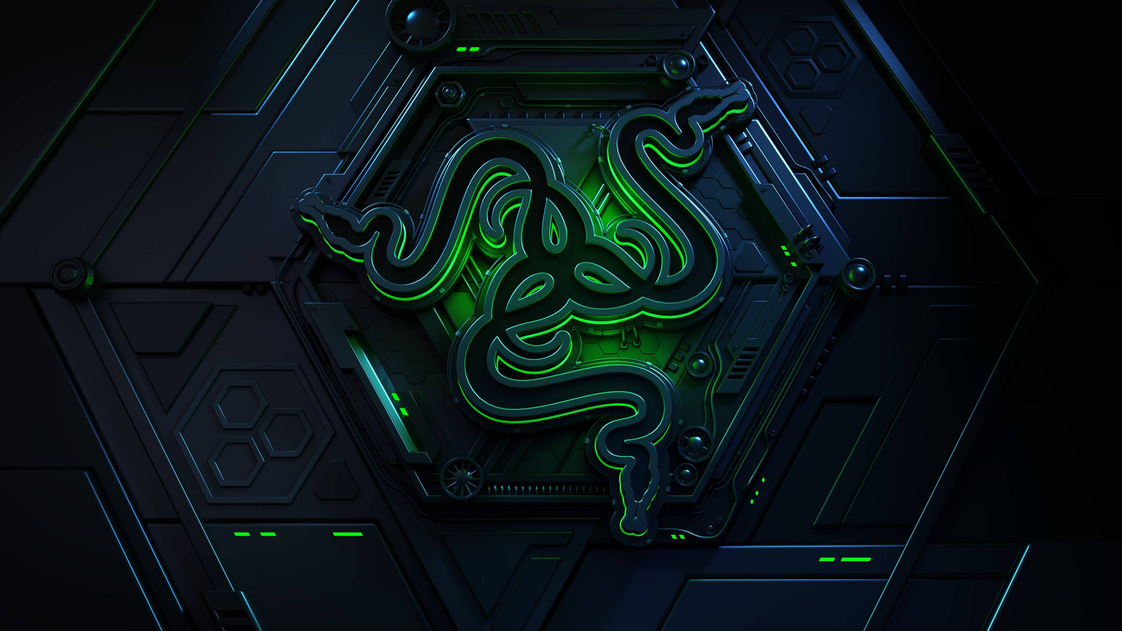 雷蛇 桌布 壁紙 — 一個發光的綠色Razer標誌嵌入在帶有六邊形圖案和霓虹色調的黑暗未來科技中。