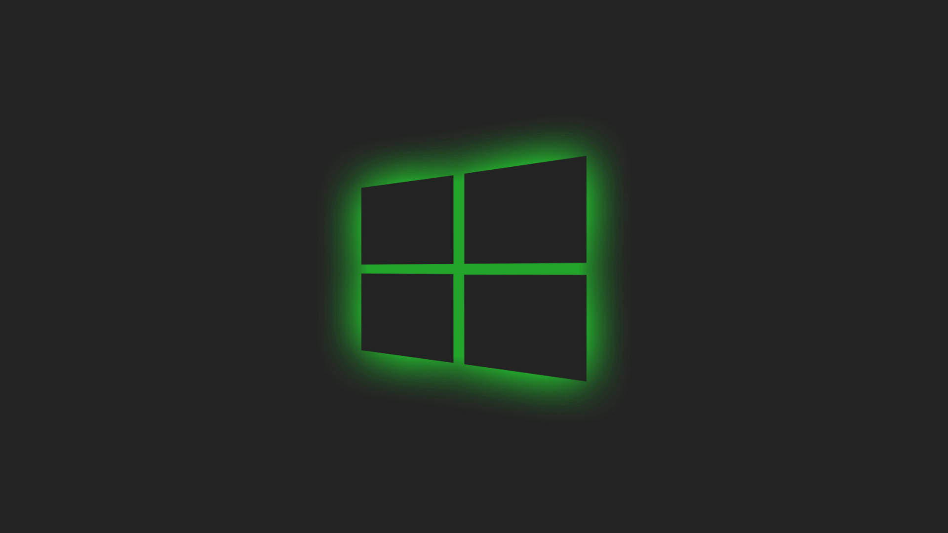 黑色 Windows 10 桌布 壁紙 — 一個發光的綠色Windows標誌，居中放置在深色背景上，帶有柔和的光暈。
