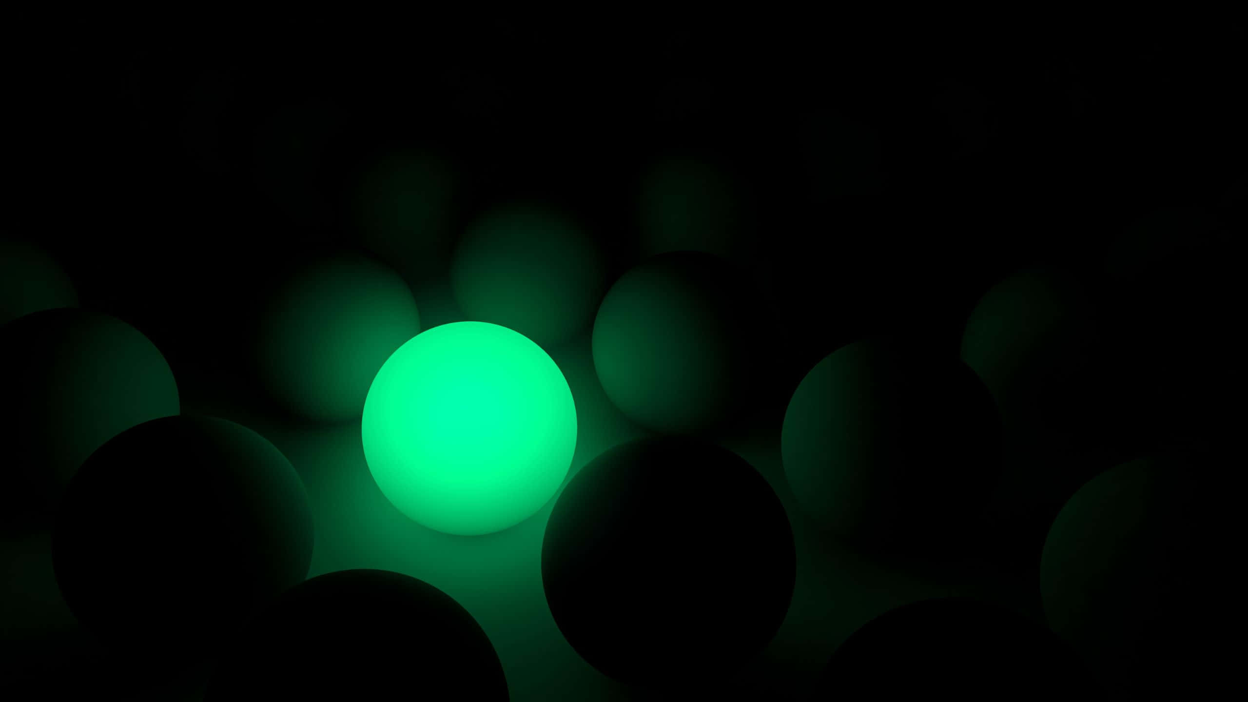 2560x1440 動態圖片 桌布 壁紙 — 一個發光的綠色球體在黑色背景上的較暗球體之間散發出光芒。