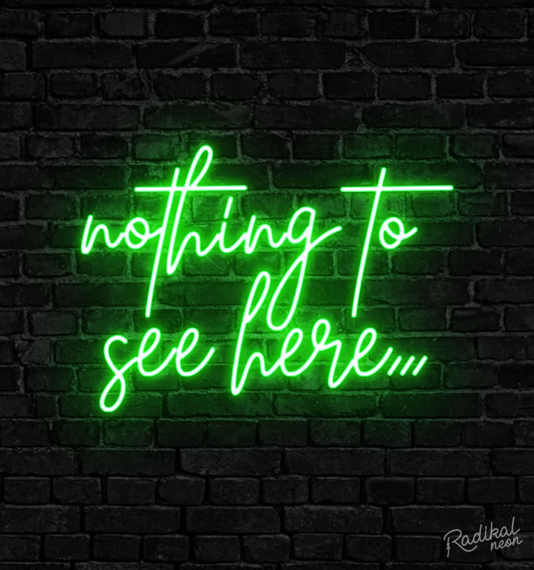 深色磚牆上一個寫著 nothing to see here 的綠色霓虹燈牌。 — 綠色美學 GIF 壁紙
