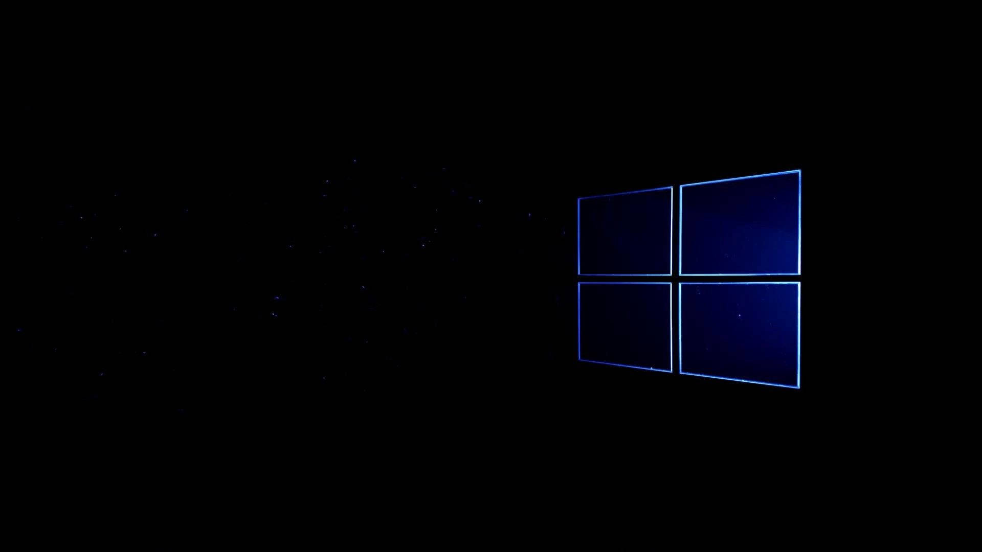 黑色 Windows 10 桌布 壁紙 — 一個發光的藍色Windows標誌漂浮在佈滿星星的黑色虛空中，散發著數位優雅。