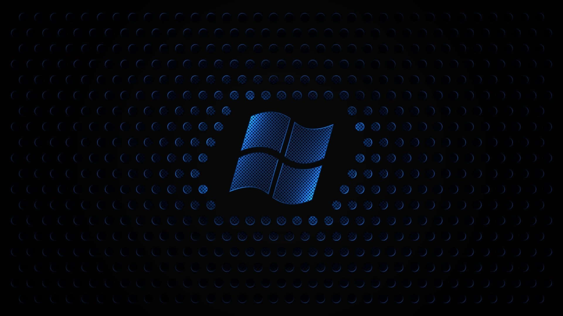 Black Desktop 桌布 壁紙 — 一個發光的藍色Windows標誌從帶有細微光反射的深色穿孔金屬表面浮現。