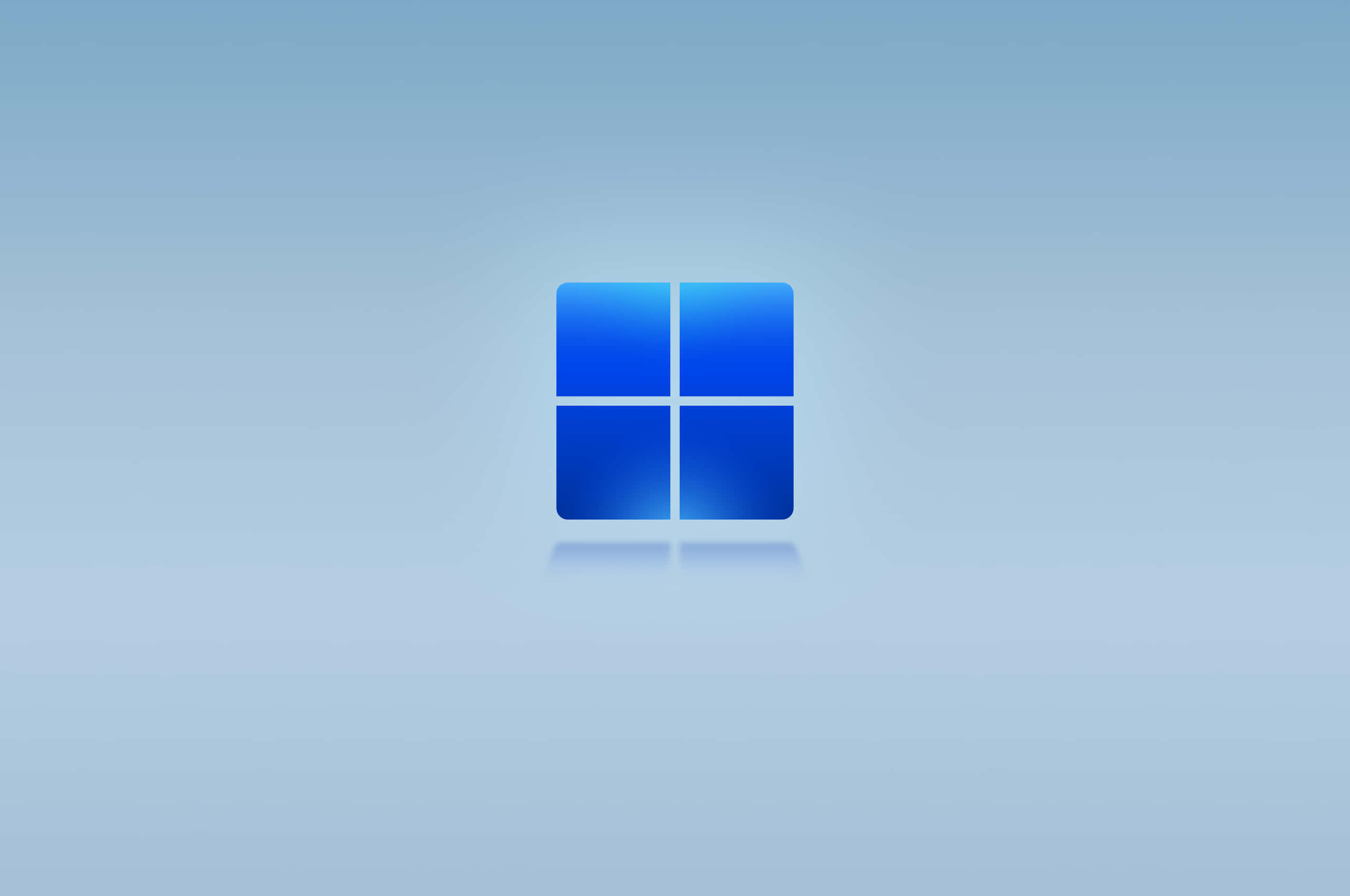 Windows Default 桌布 壁紙 — 一個發光的藍色Windows標誌，居中放置在柔和的漸變背景上，帶有微妙的反射。