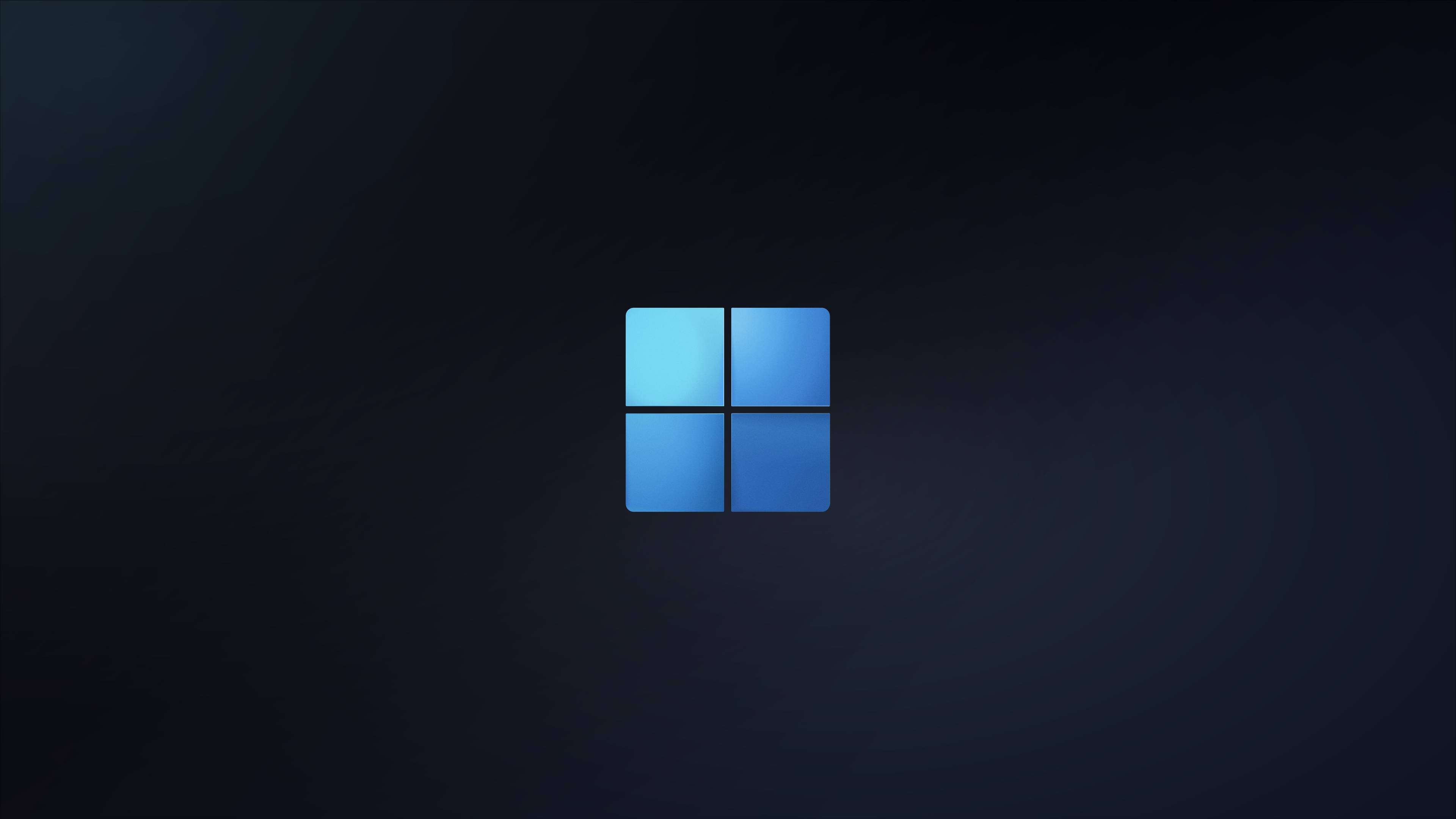 Windows 11 桌布 壁紙 — 一個發光的藍色Windows標誌，居中放置在帶有細微紋理的深色漸變背景上。