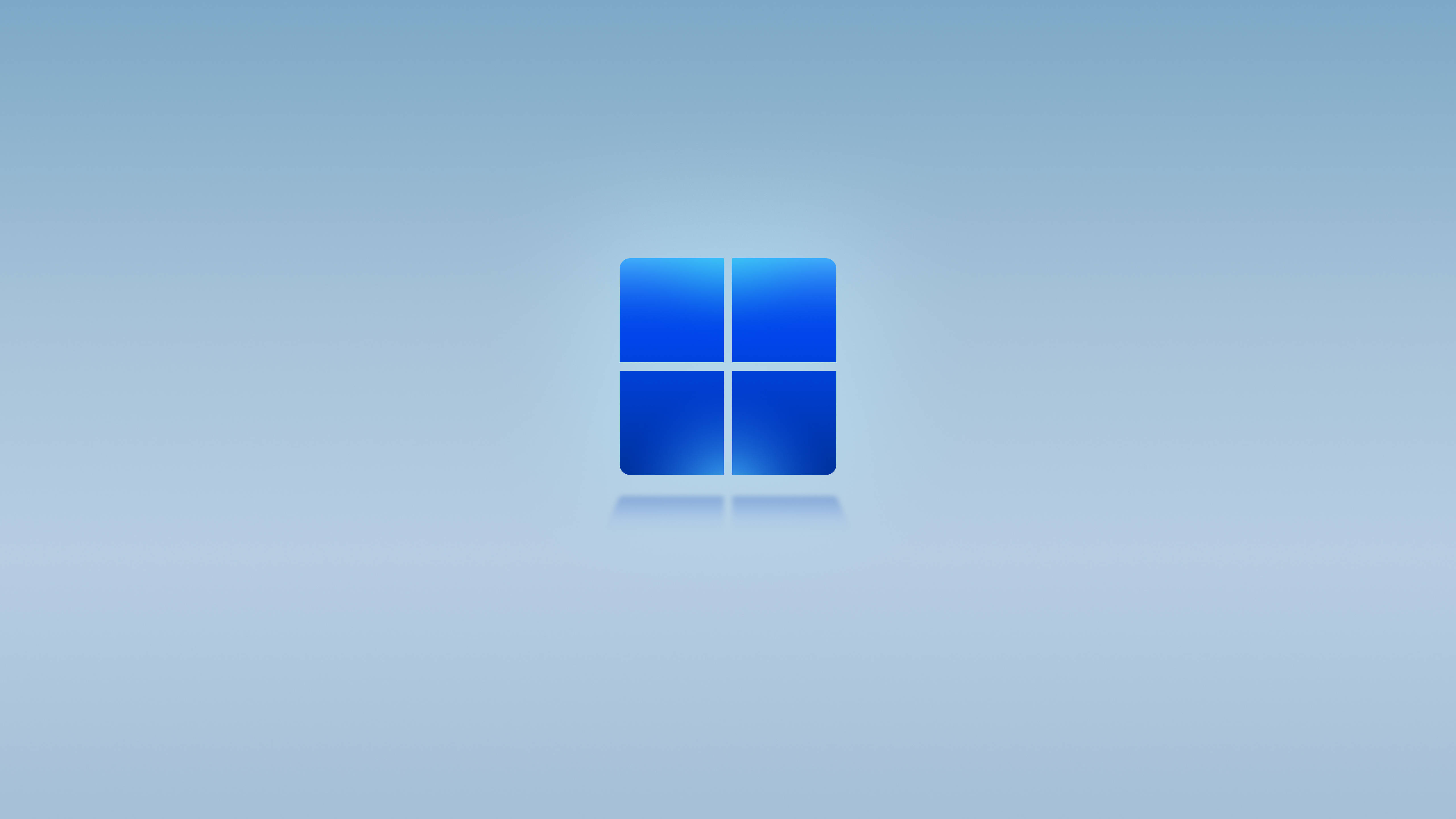 Windows 桌布 壁紙 — 一個發光的藍色Windows標誌，居中放置在柔和漸變背景上，帶有微妙的反射。