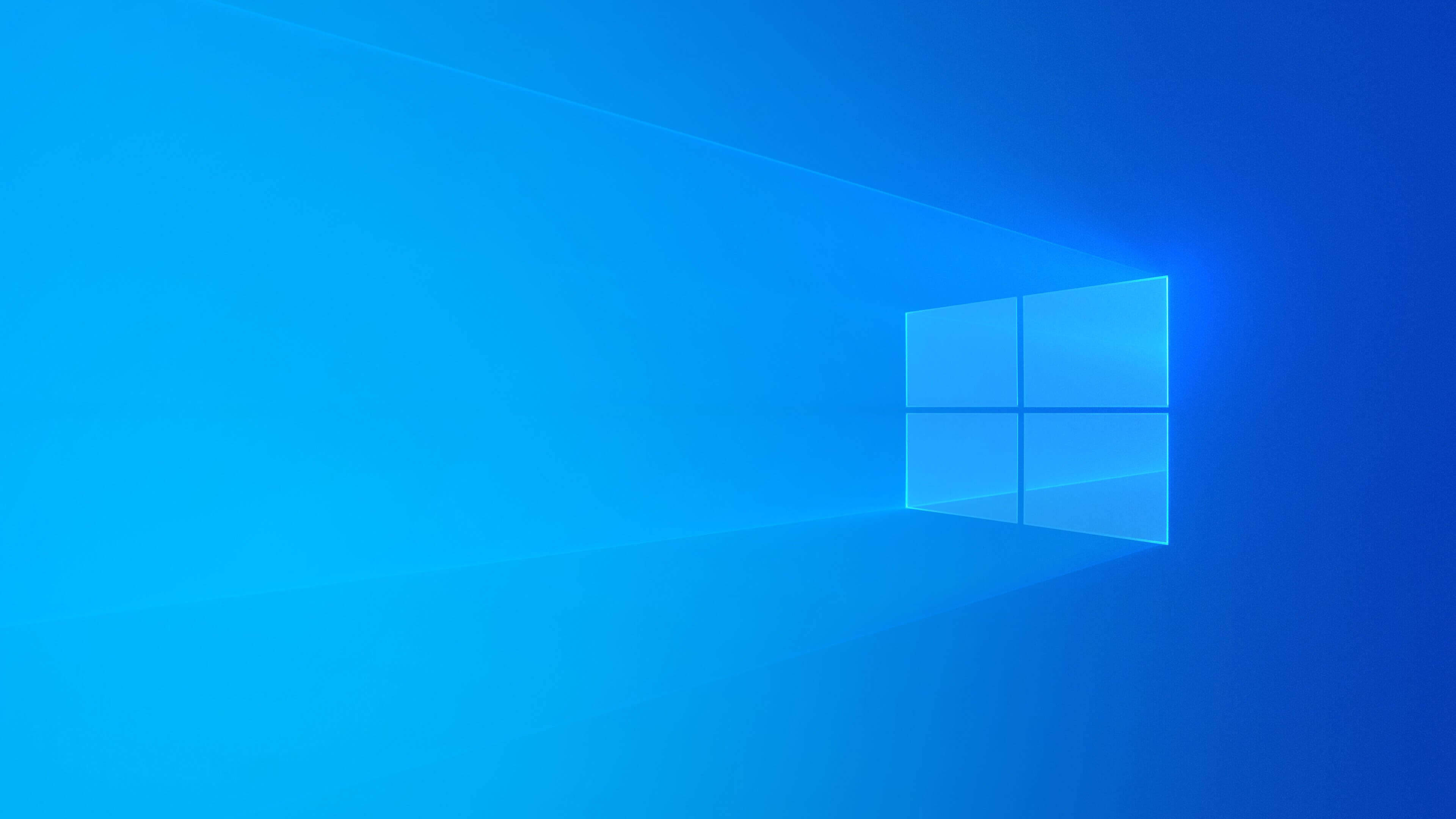 Windows 10 高畫質 桌布 壁紙 — 一個發光的藍色窗戶標誌在漸變藍色背景上投射出柔和的光線。