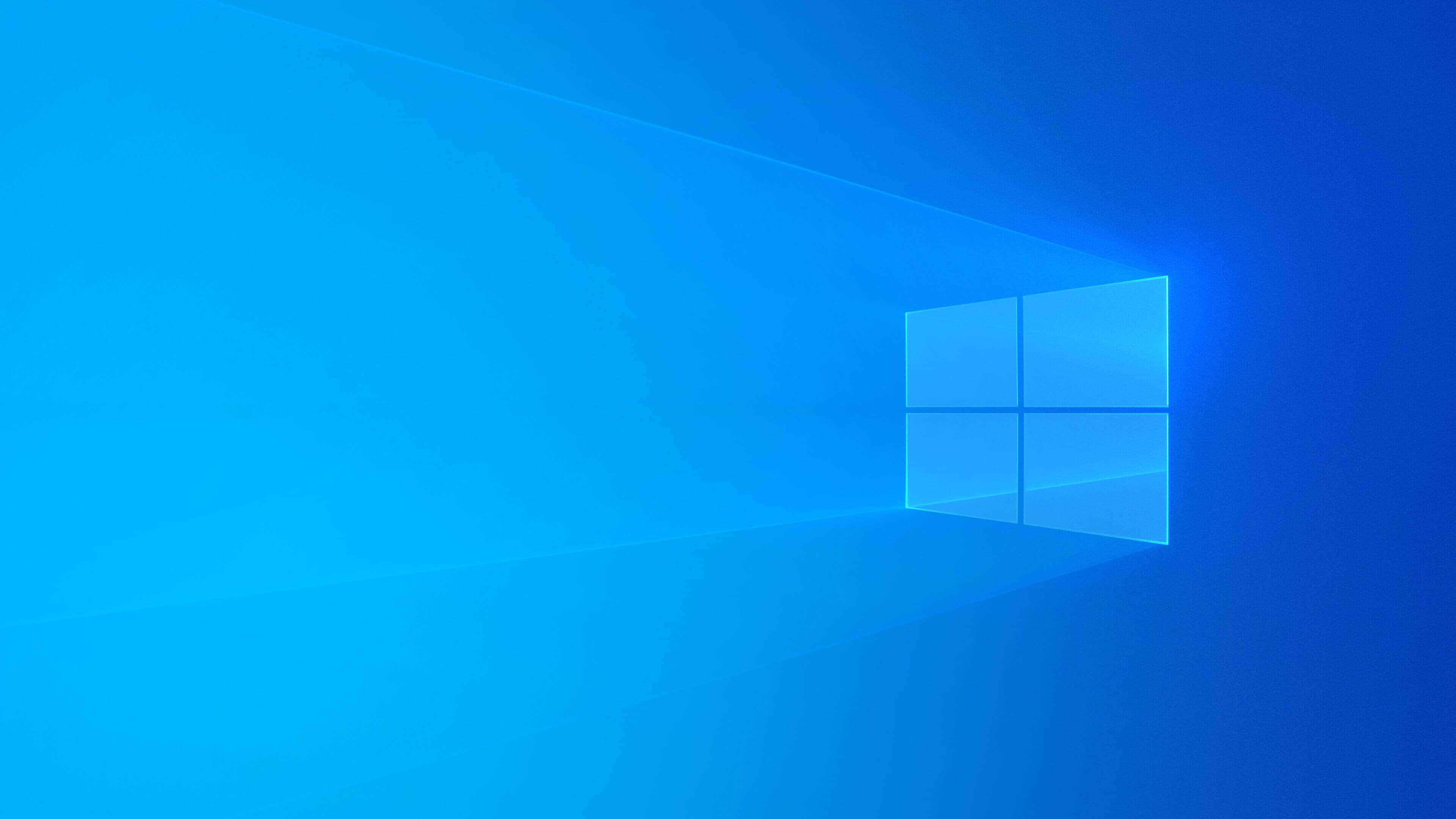 Windows Default 桌布 壁紙 — 一個發光的藍色窗戶標誌漂浮在漸變藍色虛空中，背後散發出柔和的光線。