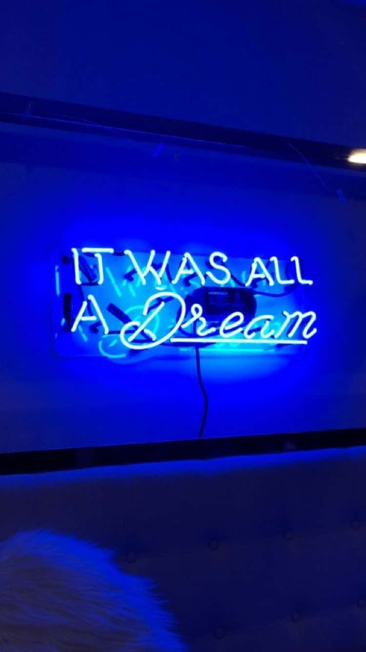 語錄 桌布 壁紙 — 一個發光的藍色霓虹燈牌寫著「IT WAS ALL A Dream」，背景是深色牆壁，下方有簇絨床頭板。